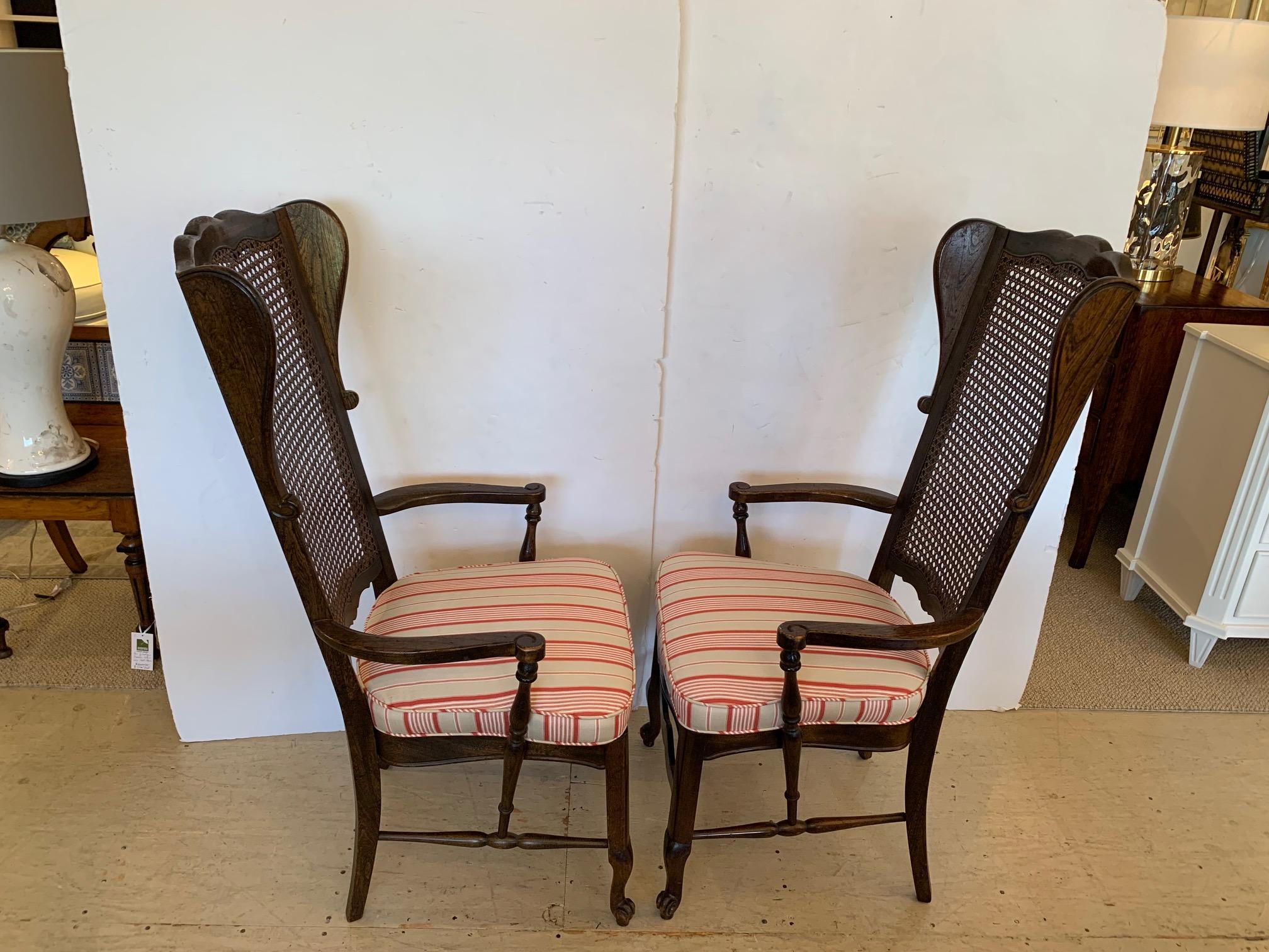 North American Stylish Pair of Caned Back Armchairs with Wings and Upholstered Seats For Sale