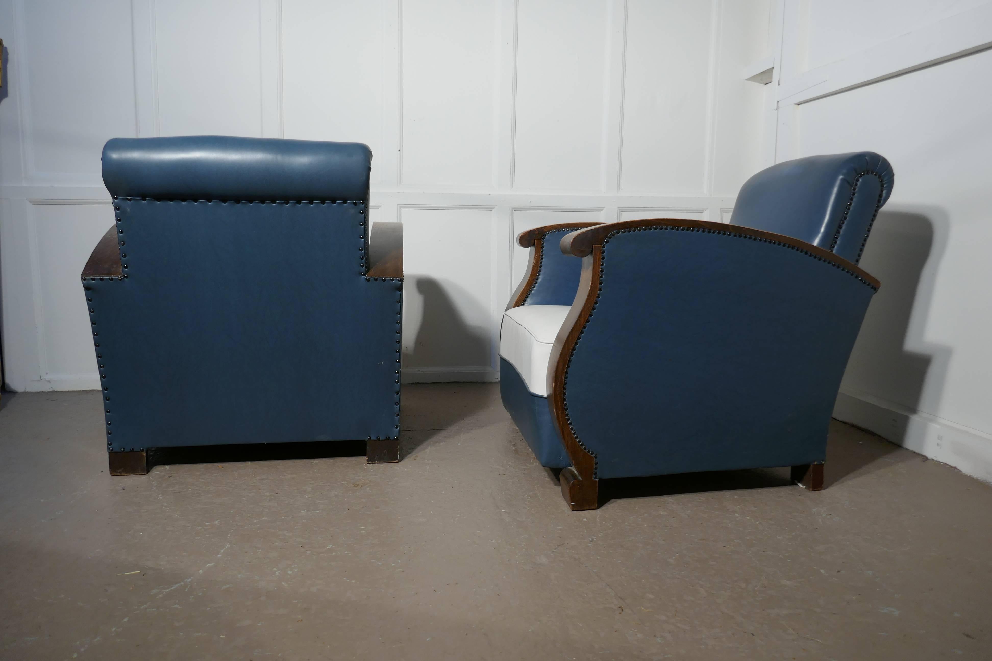 A stylish pair of French faux leather Art Deco club armchairs with walnut armrests

A very stylish pair Art Deco, walnut framed, club armchairs, the two-tone leather fabric leather is in very good condition,
The chairs have deep sprung seats