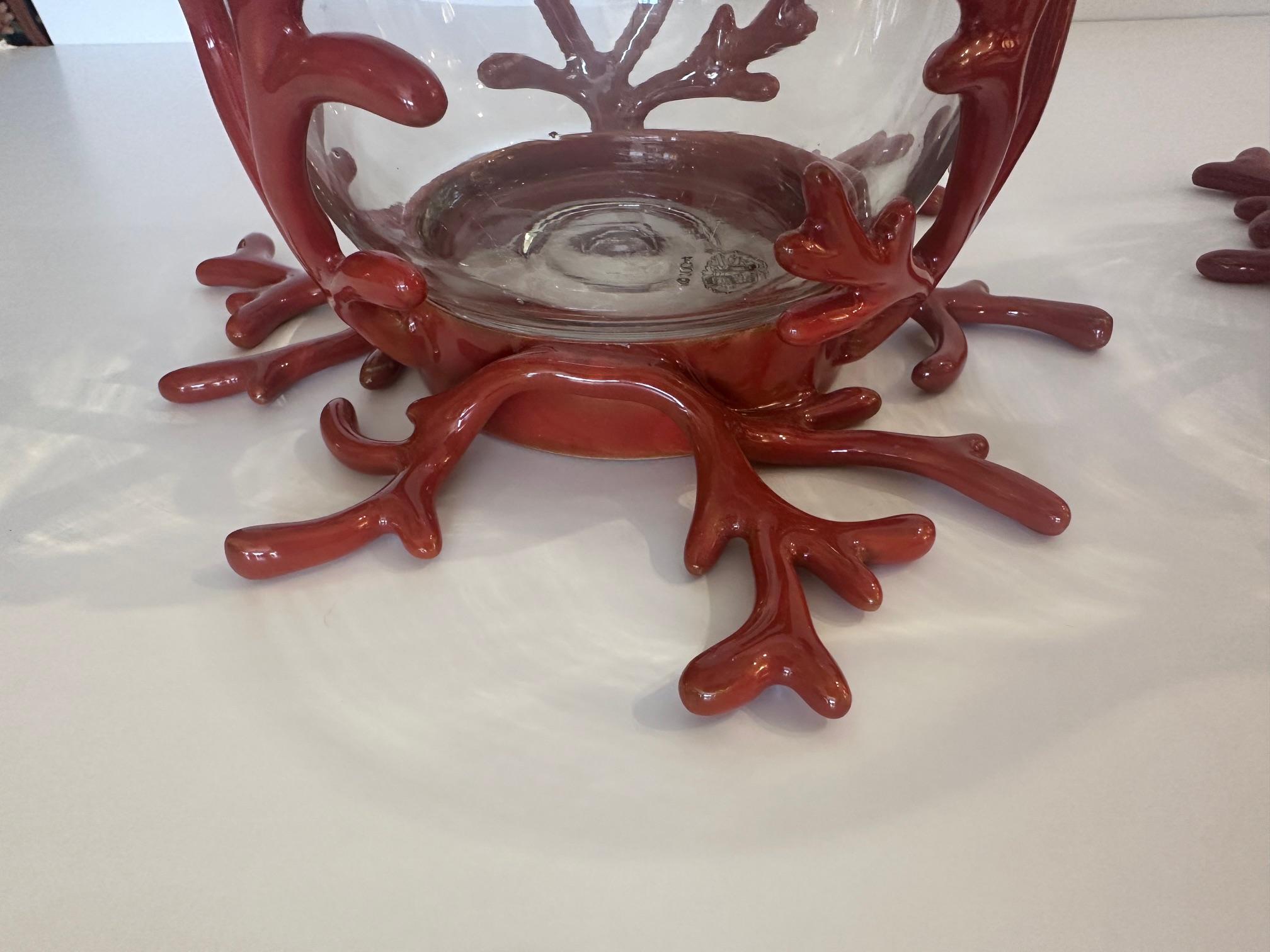 Pair of stylish glass hurricanes having faux coral iron enamel bases.
