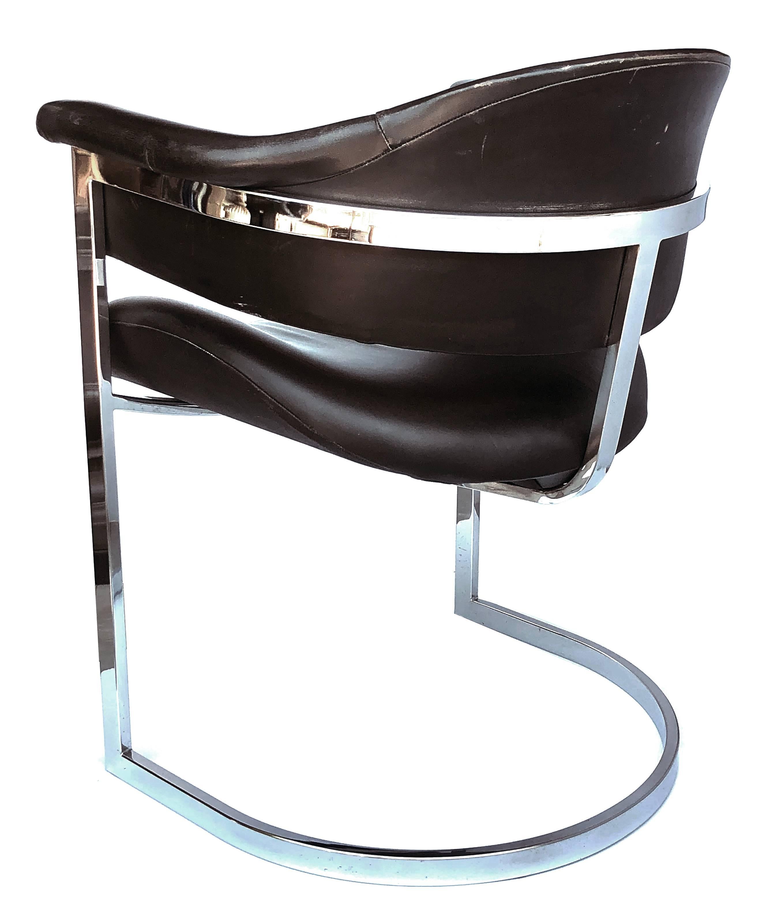 A stylish and comfortable pair of Italian chrome and black leather chairs designed by Vittorio Introini for Mario Sabot 1970's; these chic chairs with chrome frame and leather upholstery.