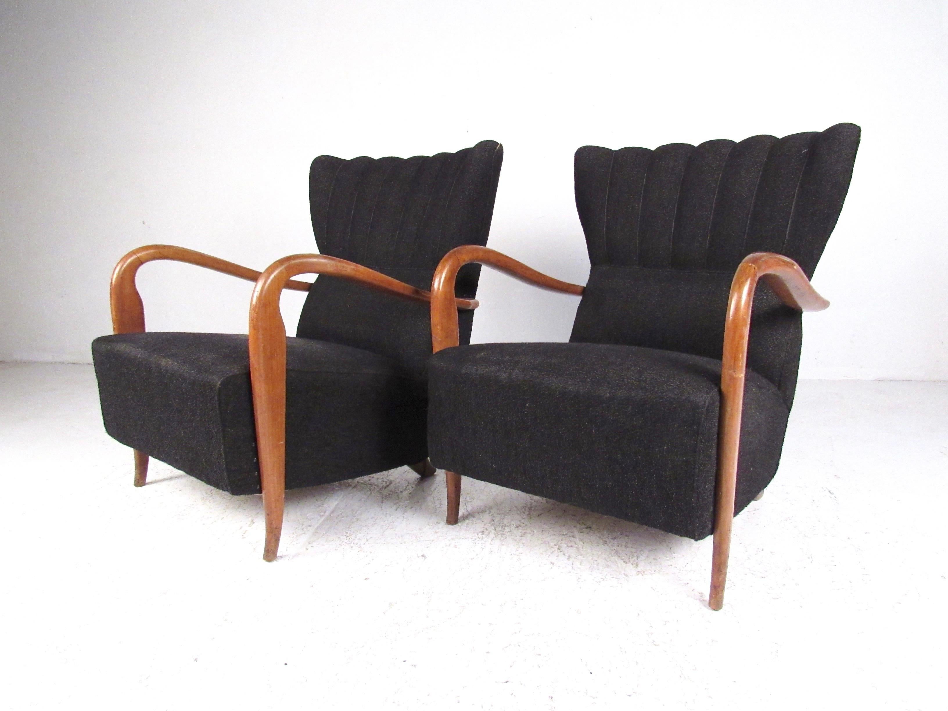 Sculptural hardwood arms wonderfully complimented by shapely seat backs and This beautiful matching pair of Mid-Century Modern armchairs make an elegant vintage addition to home or business interior.