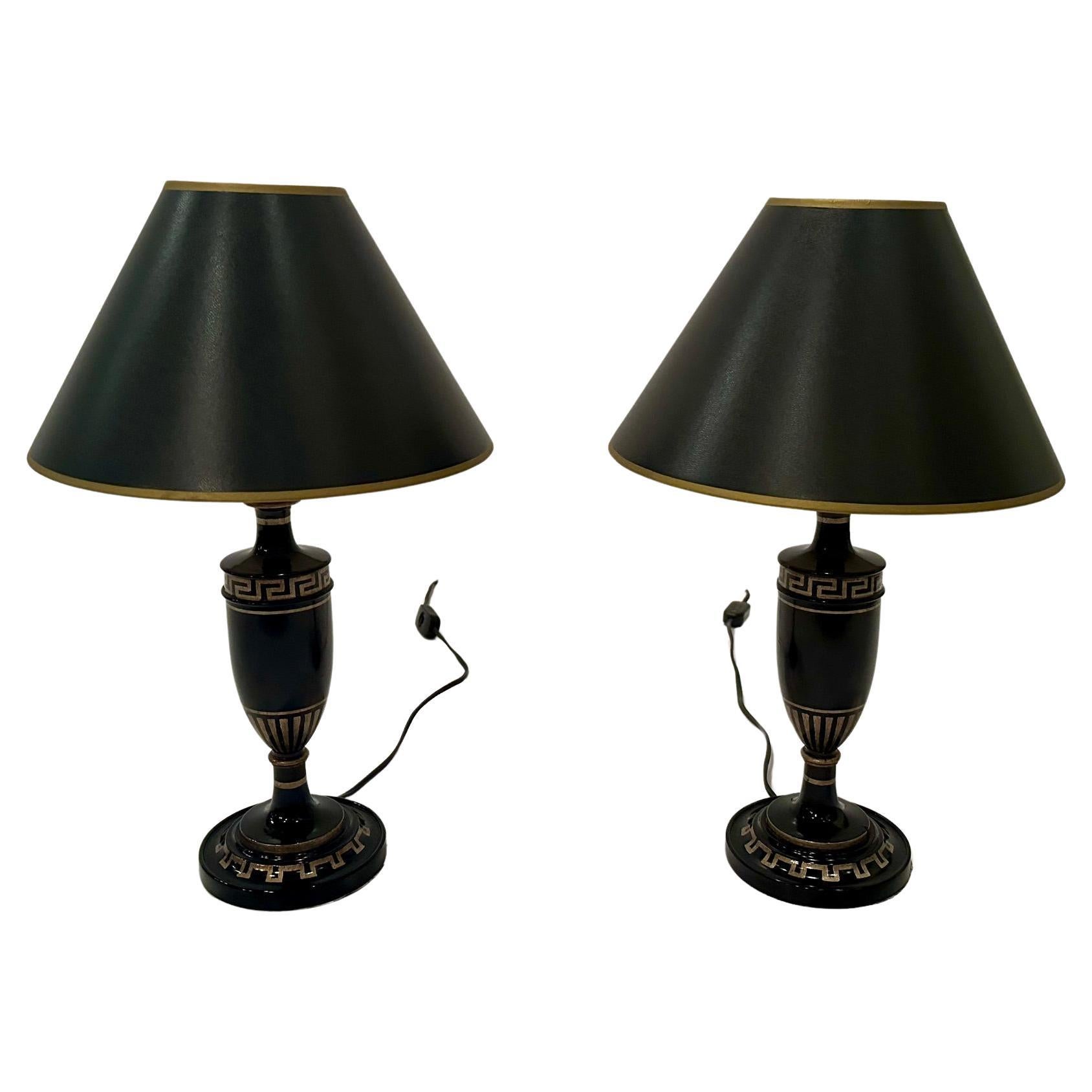 Glamorous black and gold ebonized wood table lamps having gold Greek key decoration and black lampshades.  Bases are 5