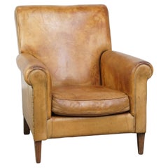 Stylish patinated vintage sheepskin armchair with a comfortable seat