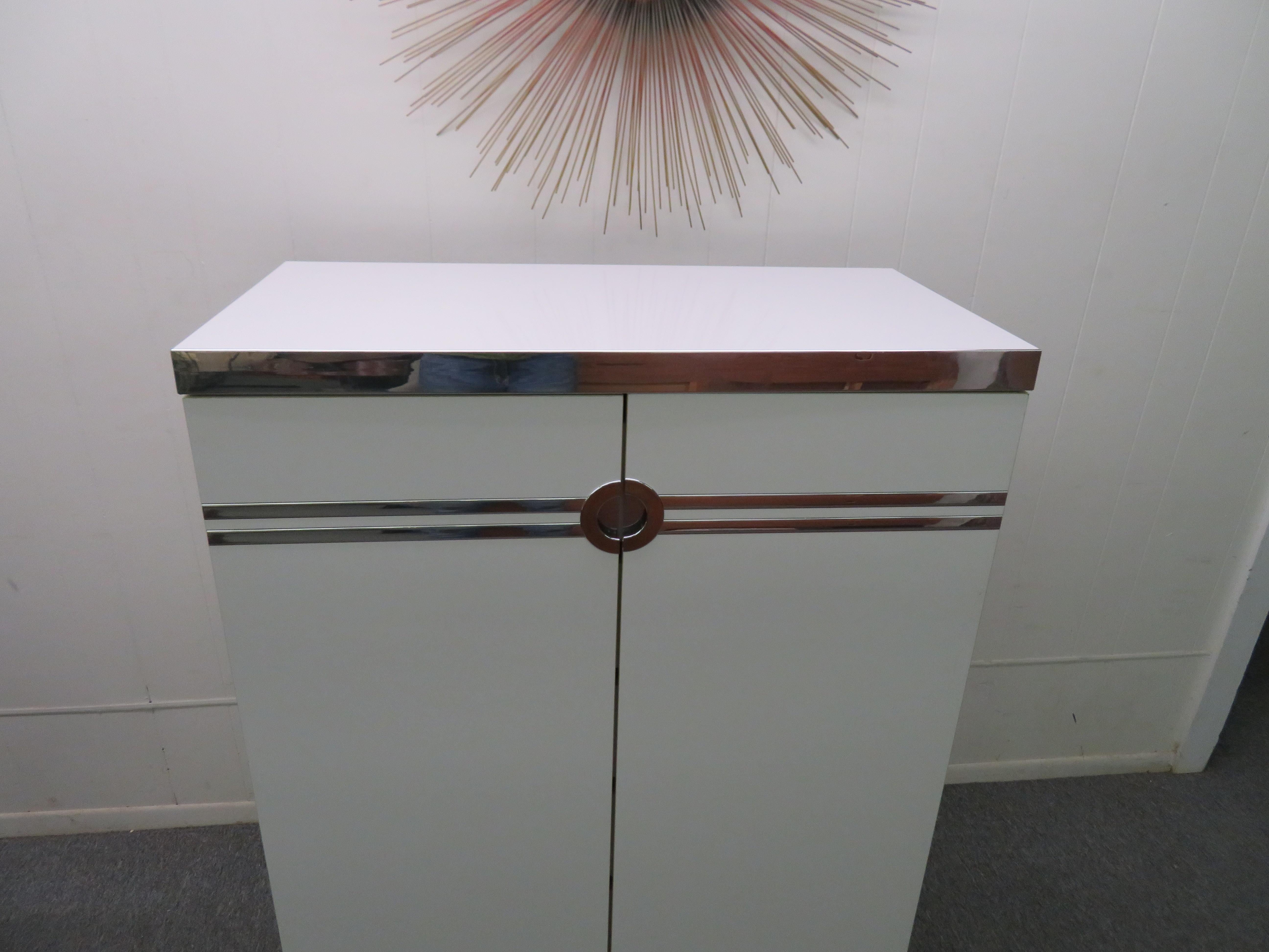 Stylish Pierre Cardin highboy or tall chest of drawers made in formica, wood, aluminium and chrome-plated accents. Simple, sleek chest of drawers in a two-door cabinet designed by Pierre Cardin for Dilingham.