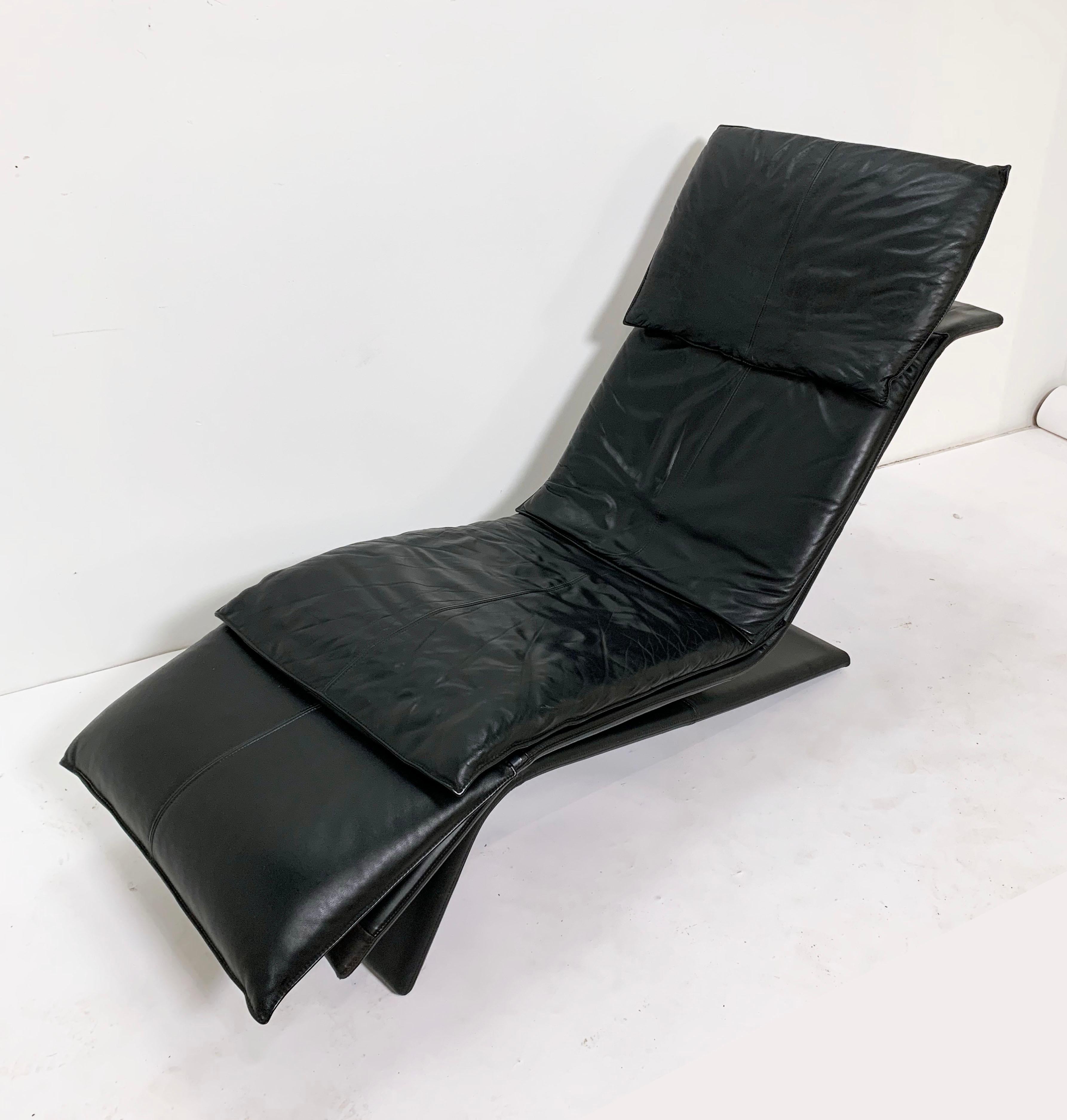 A sleek postmodern leather chaise longue sold through Maurice Villency, New York, NY, circa 1980s. Adjustable headrest and footrest.
