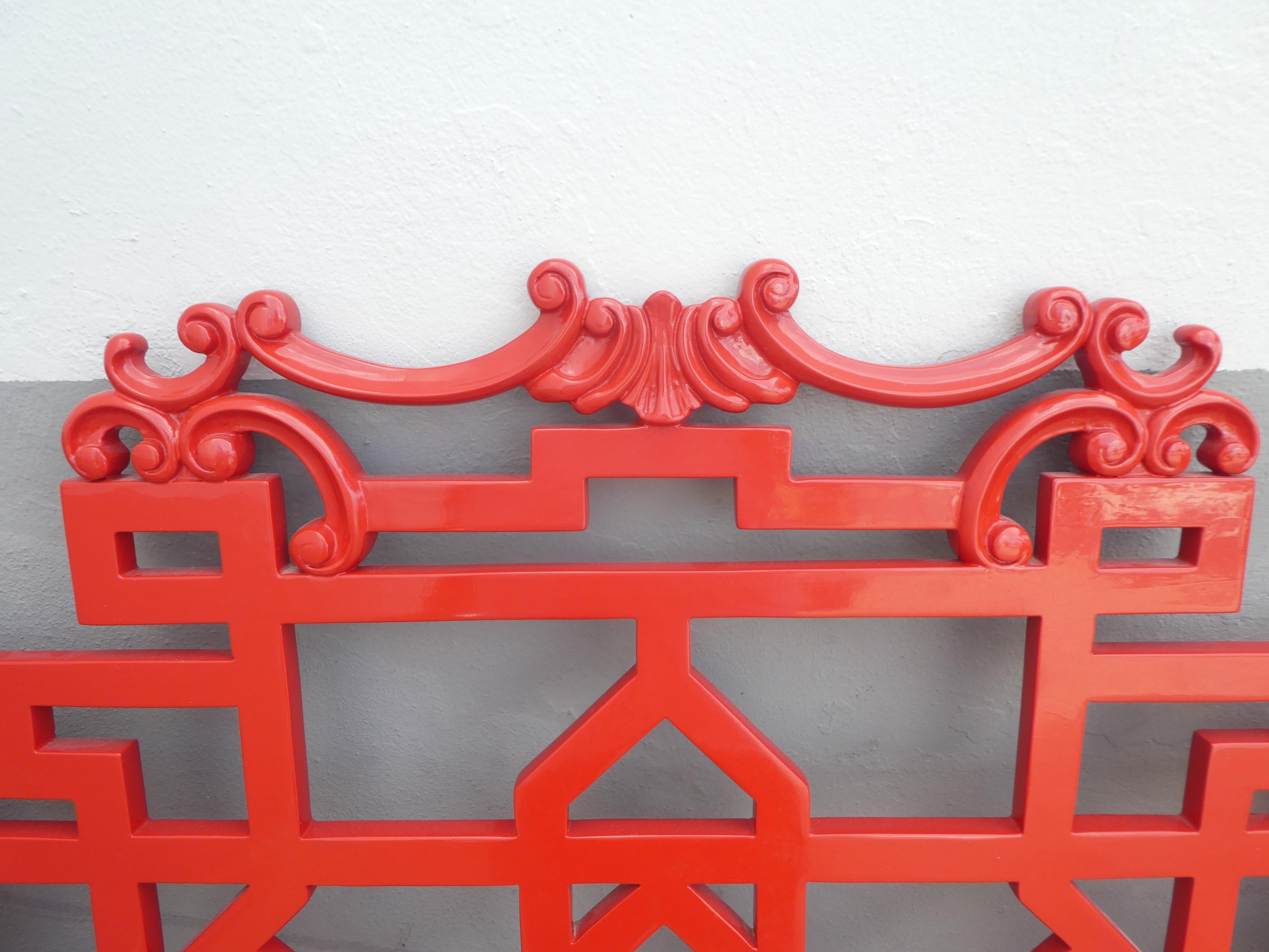 Chic king sized headboard. Red painted and carved wood. Chinese Chippendale Style. Small areas where red paint has flaked.