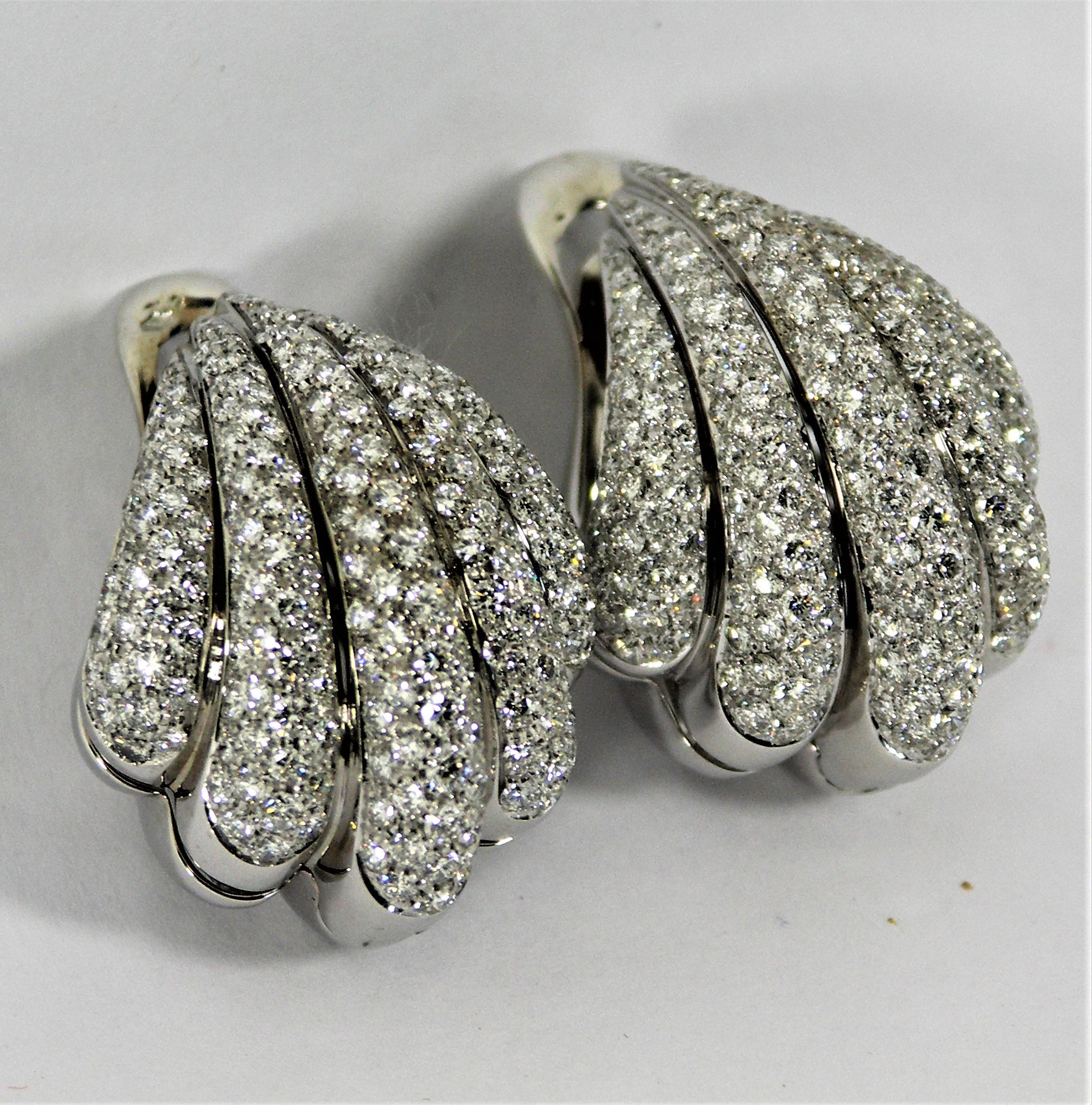Made in Italy, these stylish 18K White Gold earrings are encrusted with approximately
8.00CT of F/G Color VS1 clarity diamonds. The clever construction, with the entire
back side of the earring dropping down and opening up, makes it very easy to