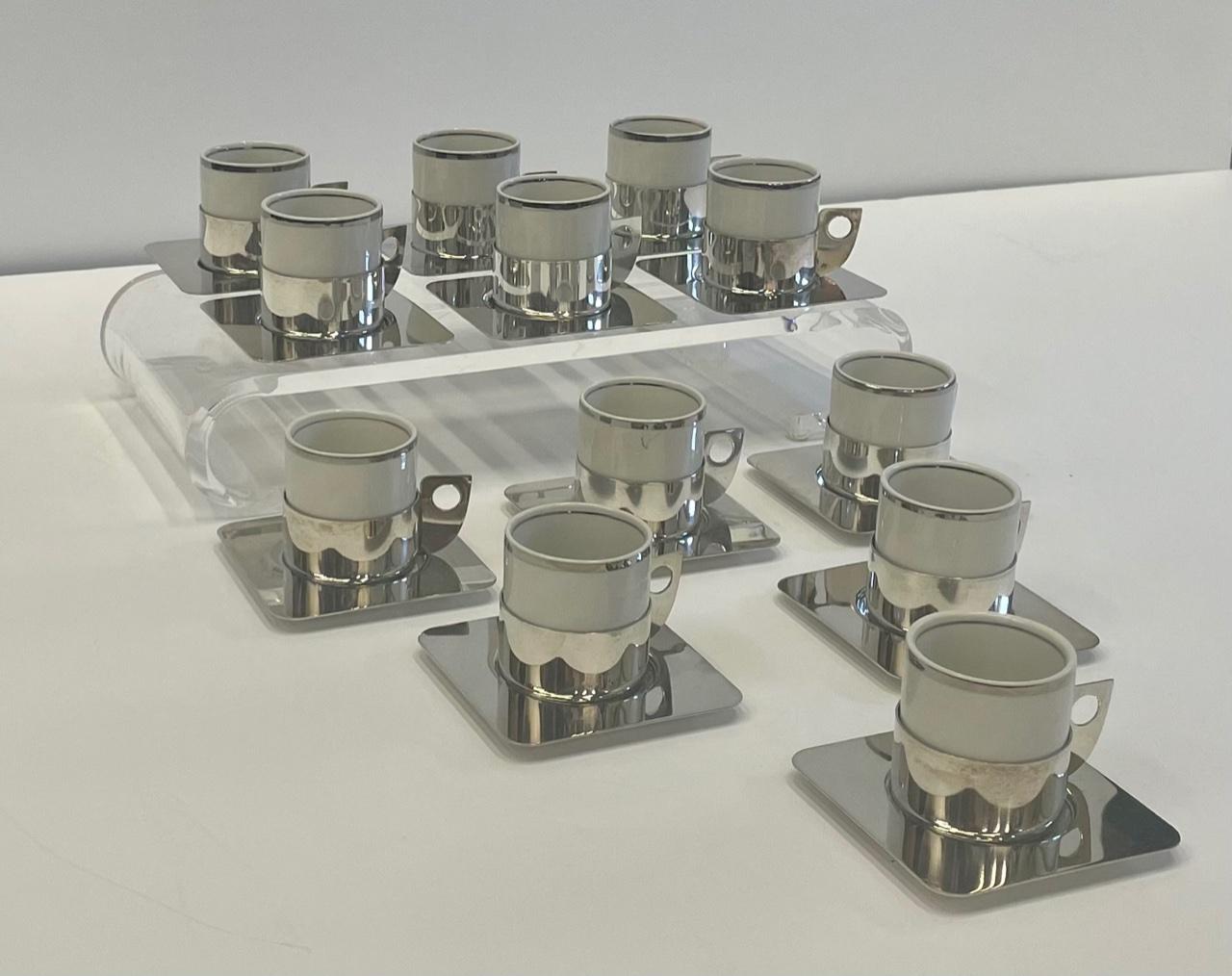 Stylish set of 12 demitasse cups and saucers having a mix of silver plate and white porcelain. Cups are 2