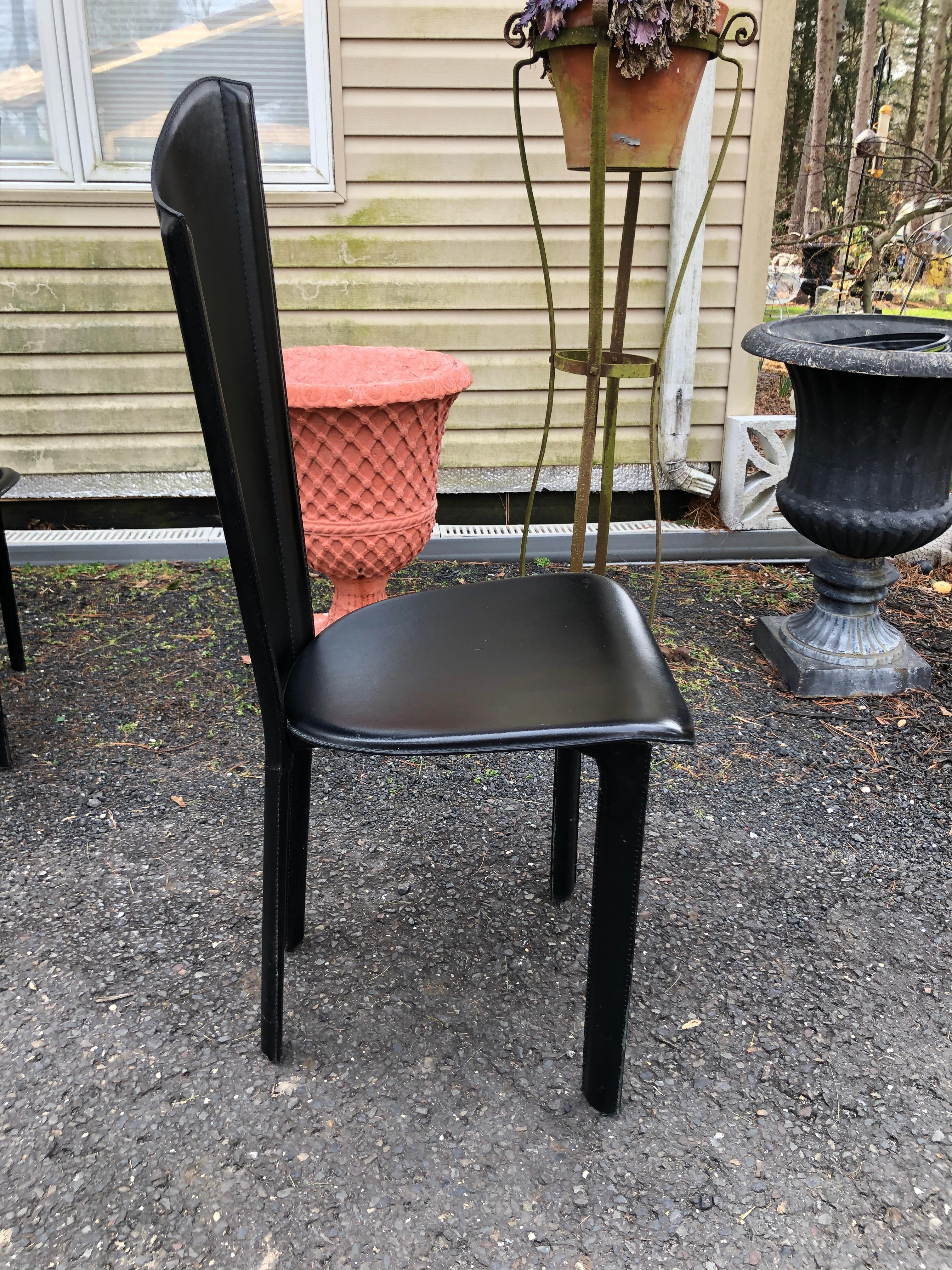 Well kept set of 8 Italian black leather asymmetric high back dining chairs. No rips or tears on leather. Nice Italian design. Sturdy and strong and surprisingly comfortable.  These black leather dining chairs are by Cattelan Italia similar to