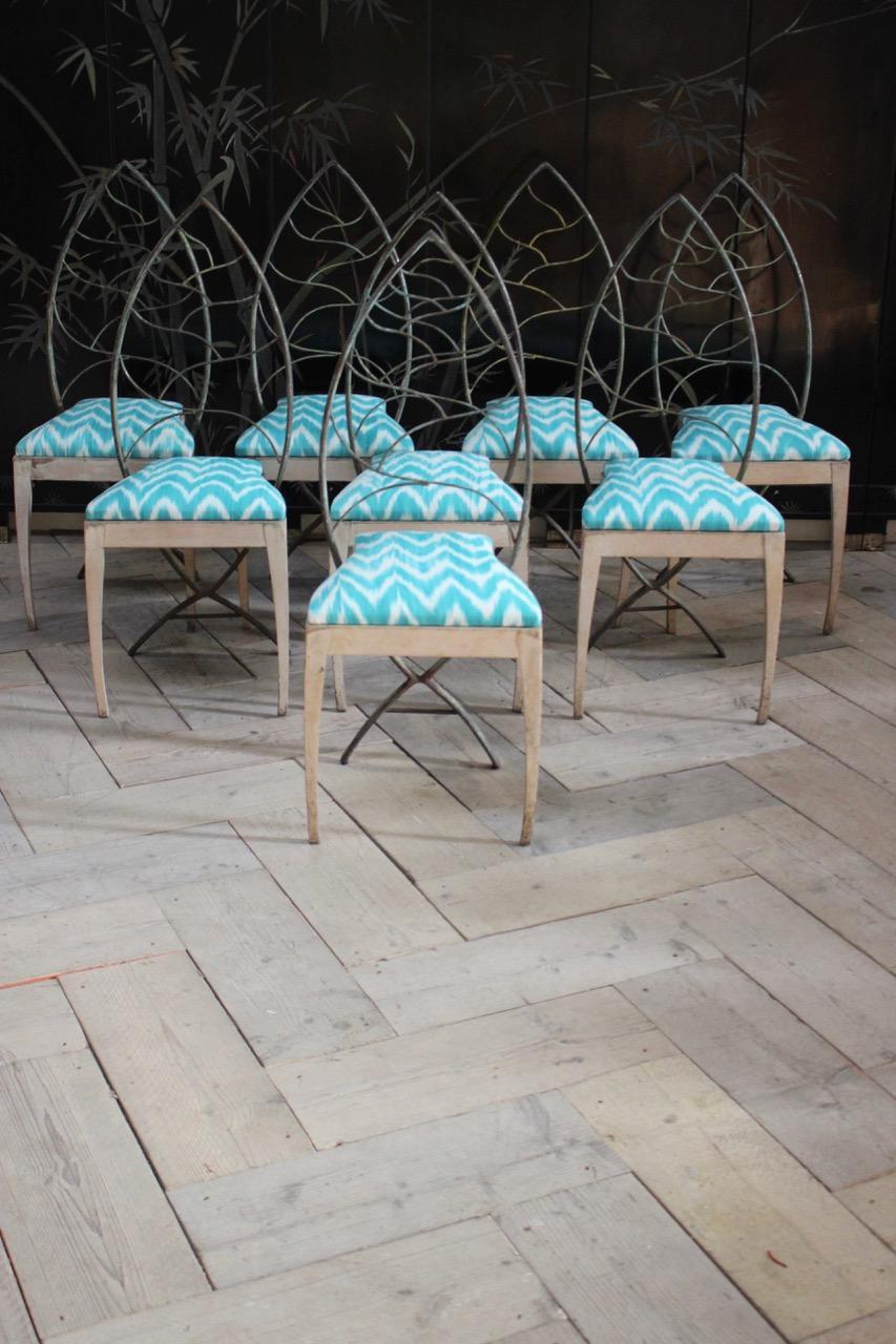 A very stylish set of eight, circa 1940s dining chairs in painted metal and wood, in the shape of leafs , retaining the original decoration, having been reupholstered by us in a Mallorcan Ikat fabric. 

This unusual set of dining chairs will make