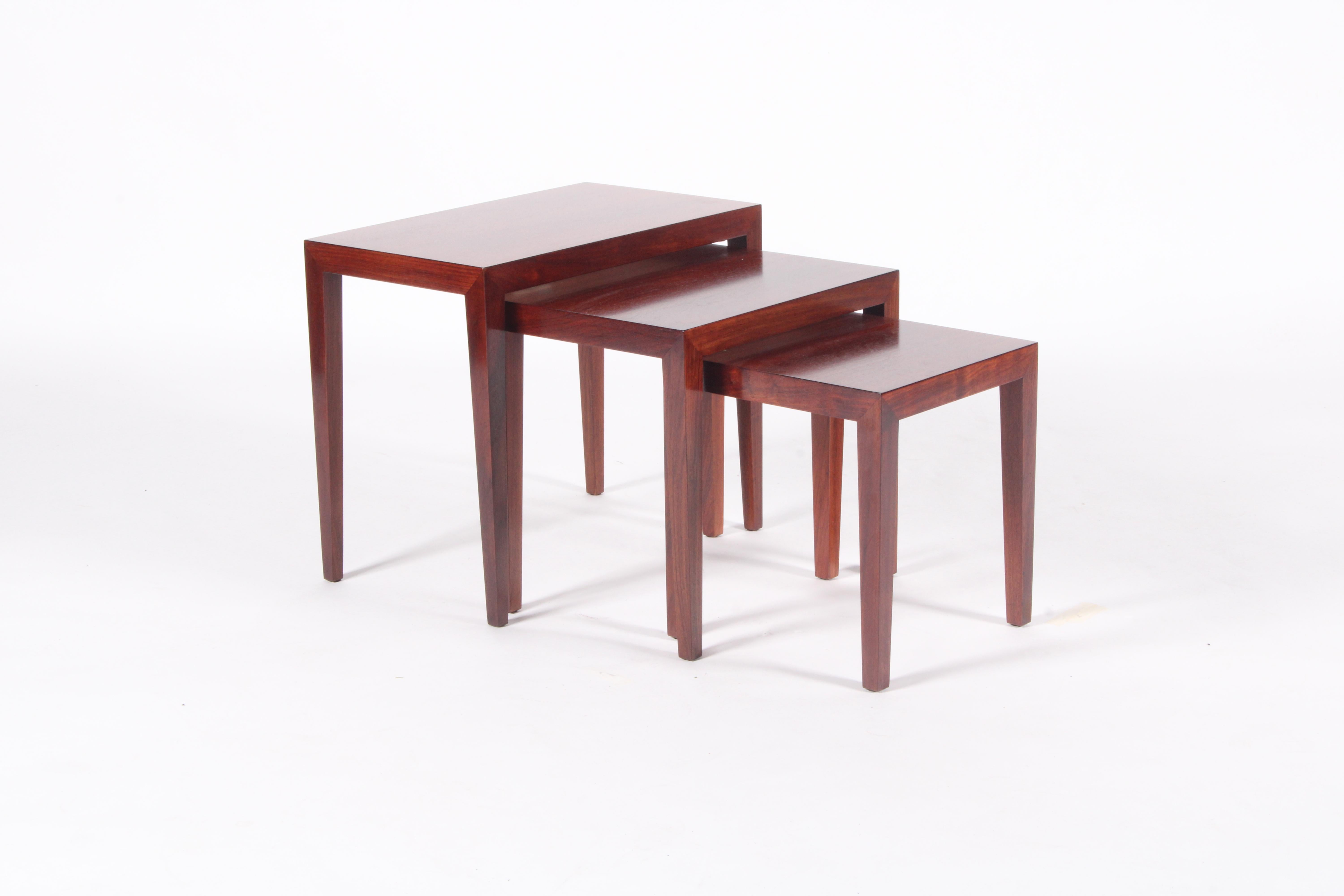 Stylish trio of nesting tables in rosewood by Danish designer Sevrin Hansen circa 1960. This charming set is beautifully proportioned and reflects the distinctive functional and elegant aesthetic of Danish design. Professionally restored this nest