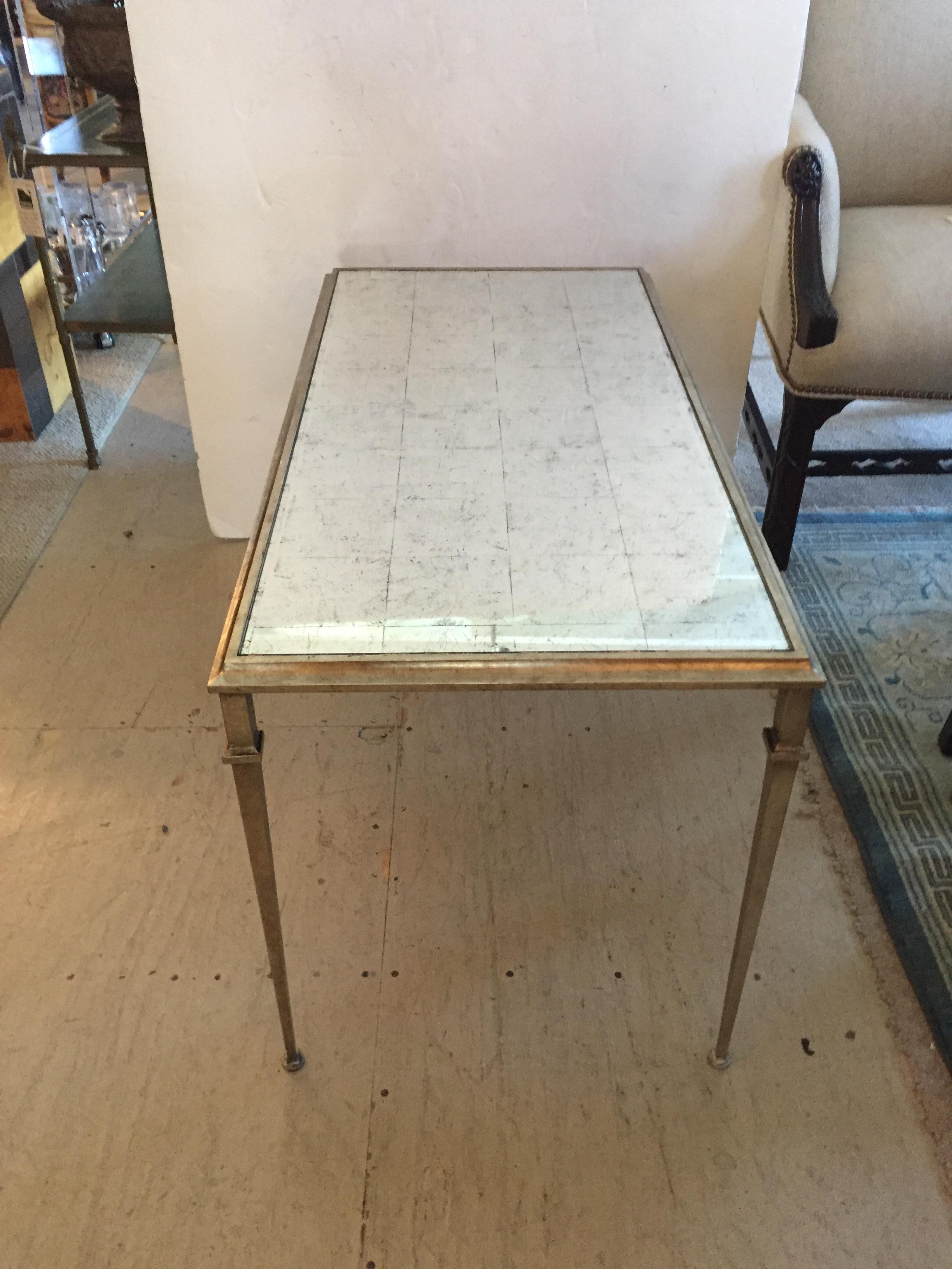 Elegant silver leafed coffee table with an antiqued mirror surface. This table is constructed of silver leafed steel; the top is in an antiqued mirror. Made by Lillian August for Drexel Heritage.
 