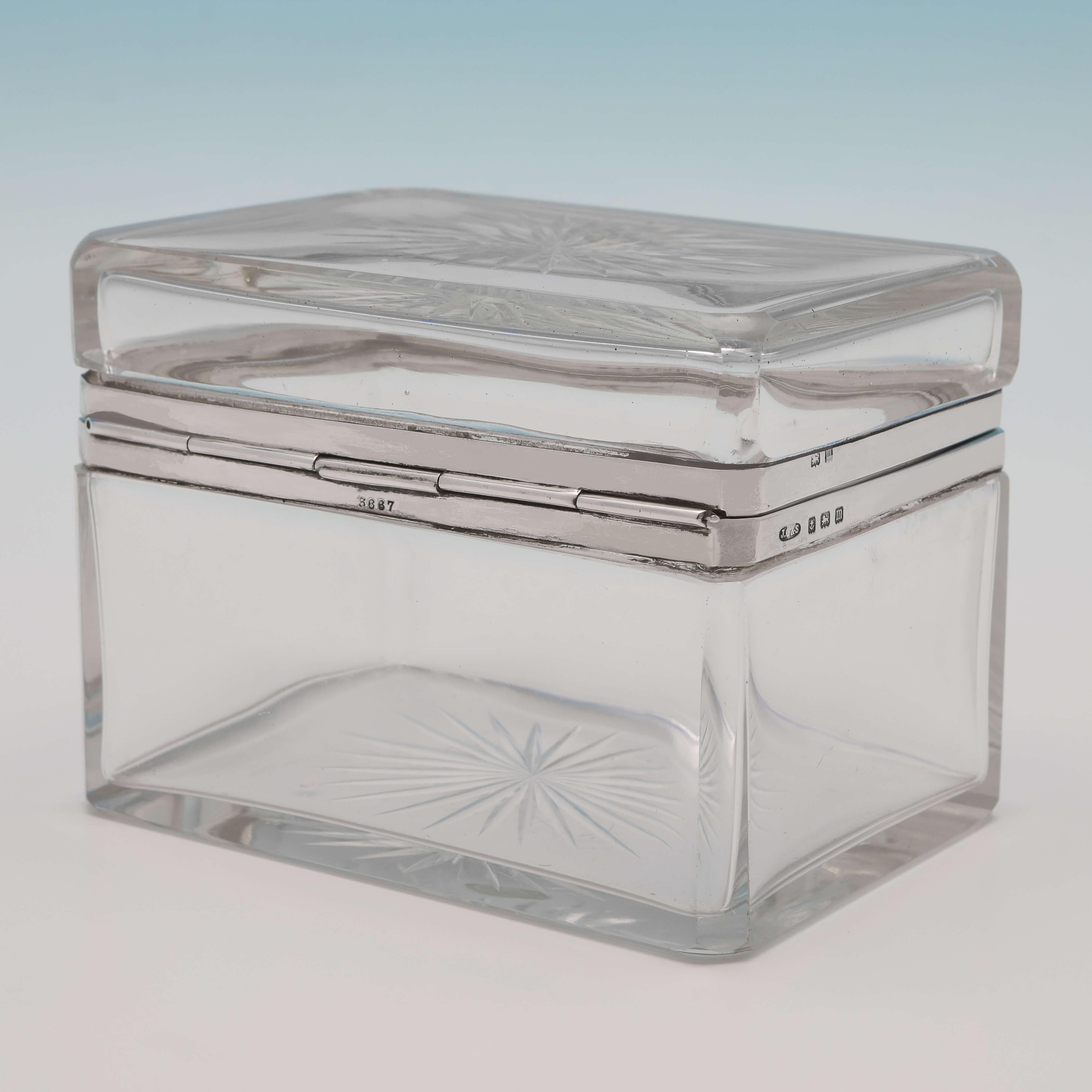 Hallmarked in Birmingham in 1911 by John Grinsell & Sons this handsome Antique, sterling silver and glass box is very stylish in design. 
The box is very usable, and would be equally at home on a bar or on a dressing table. 

The box measures