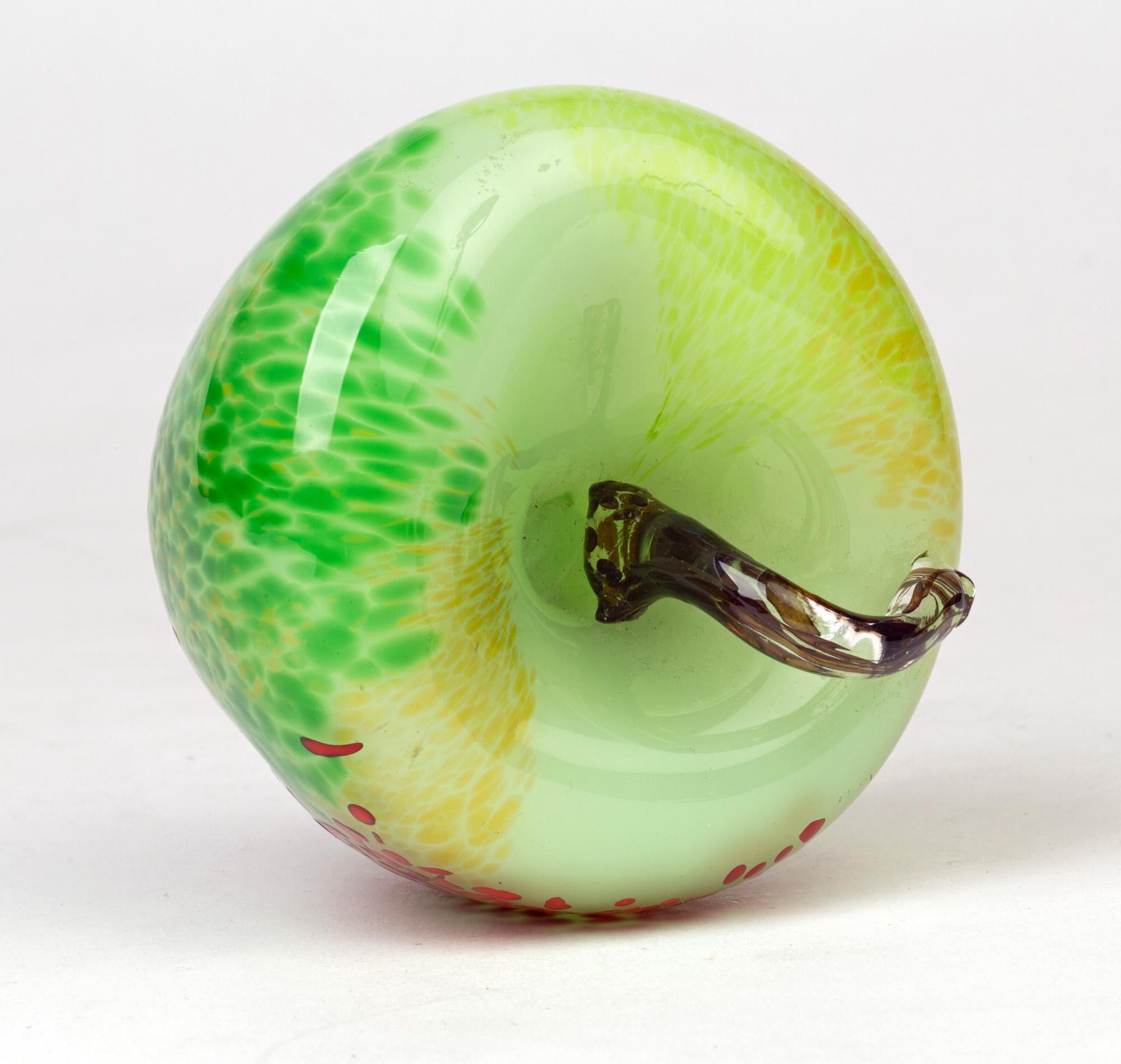 A very stylish modern studio glass paperweight or ornament in the form of a large apple indistinctly signed and dated 2007. The apple is of rounded and slight distorted shape with a clear glass cased light green body with yellow, and darker green