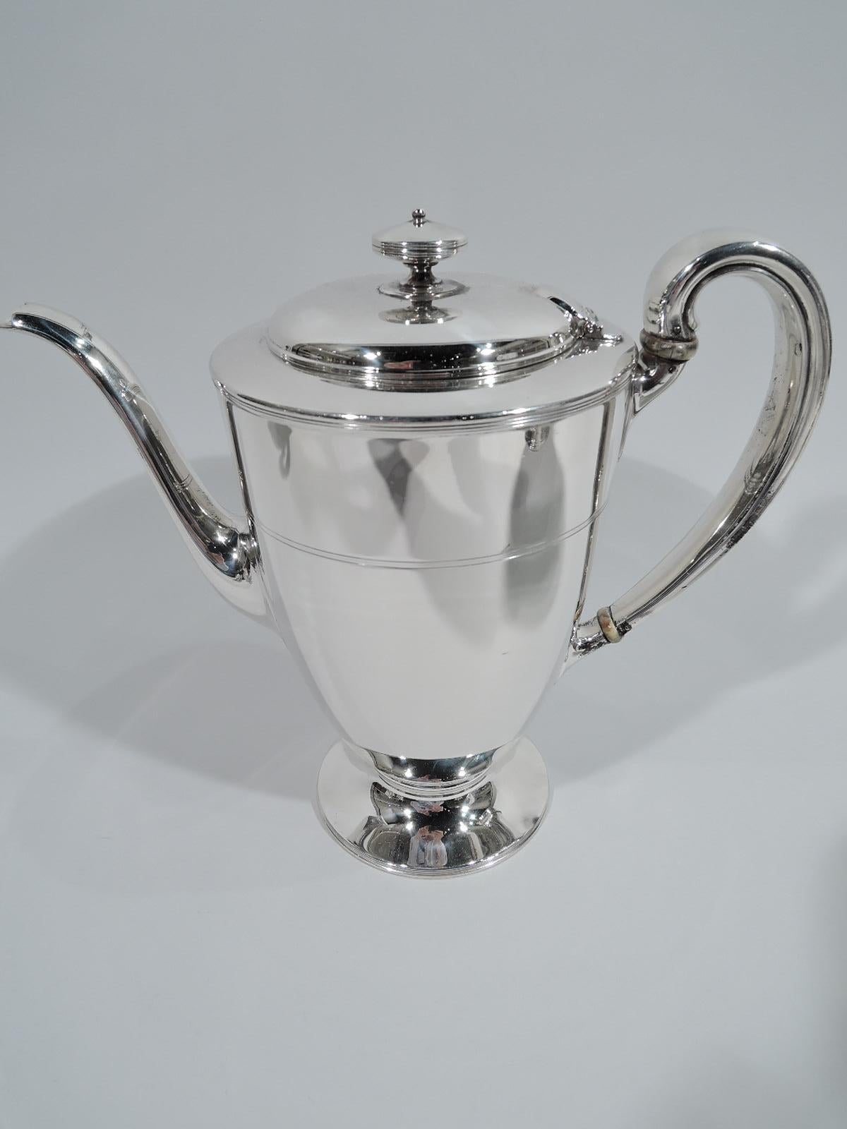 Edwardian Modern sterling silver coffee and tea set. Made by Tiffany & Co. in New York, ca 1907. This set comprises coffeepot, teapot, creamer, sugar, and waste bowl.

Each: Ovoid body with round and raised foot. Handles high looping except waste