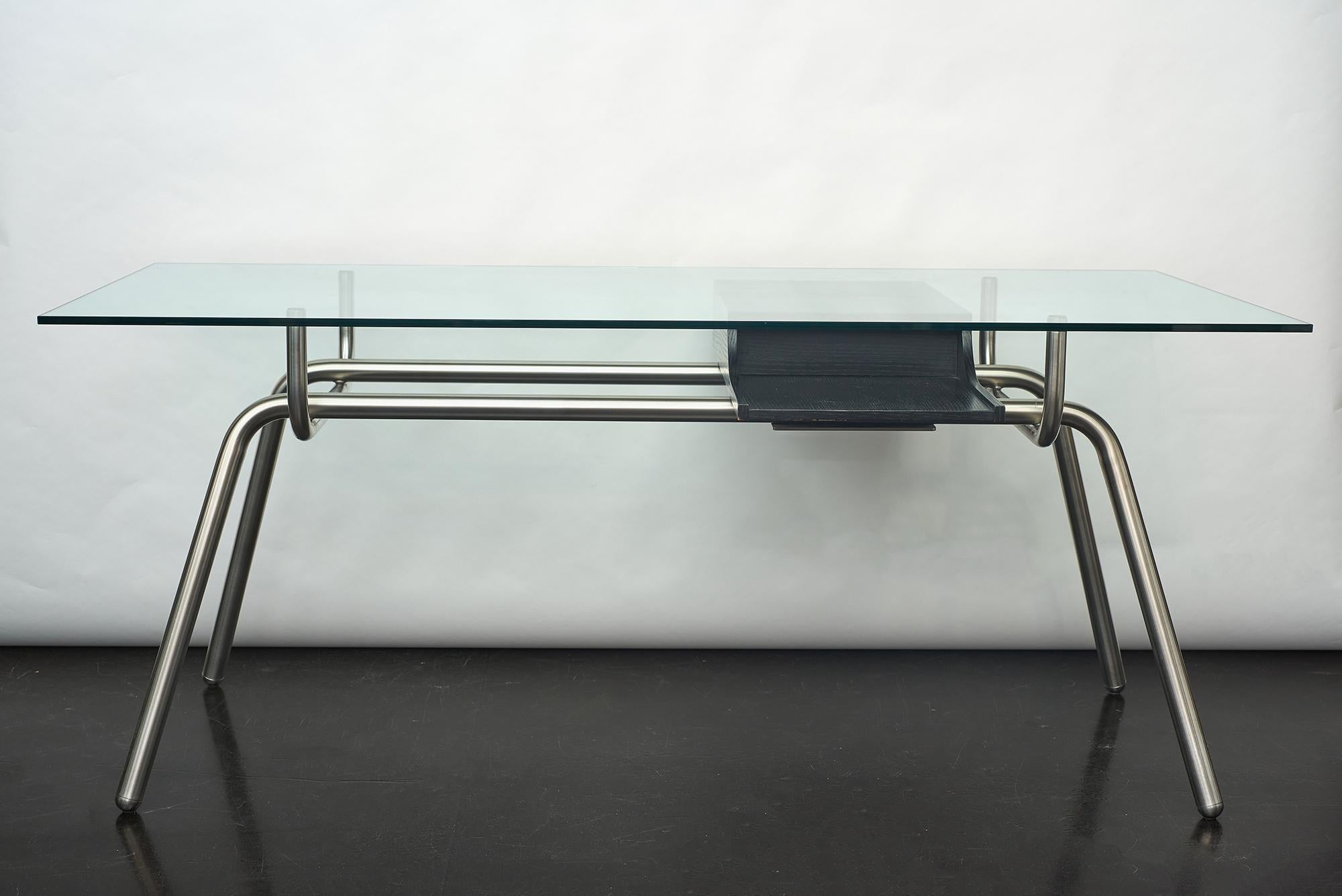 Stylish design!
Glass-top executive desk on elegant tubular steel structure with 2-sided sliding drawer.
Excellent condition.
