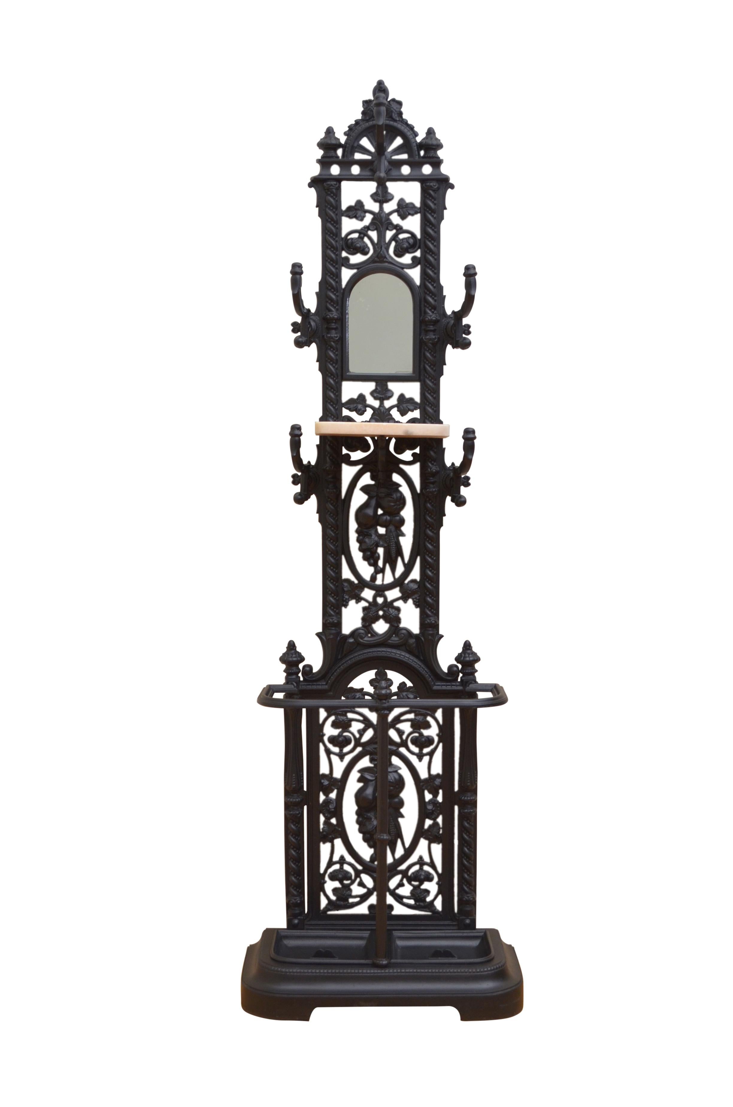 K0386 Very decorative, Victorian cast iron hall stand, having, arched mirror to back and 5 coat hooks with marble shelf, over umbrella holder all with fruit and floral decoration throughout. This cast iron coat stand is in excellent condition, ready