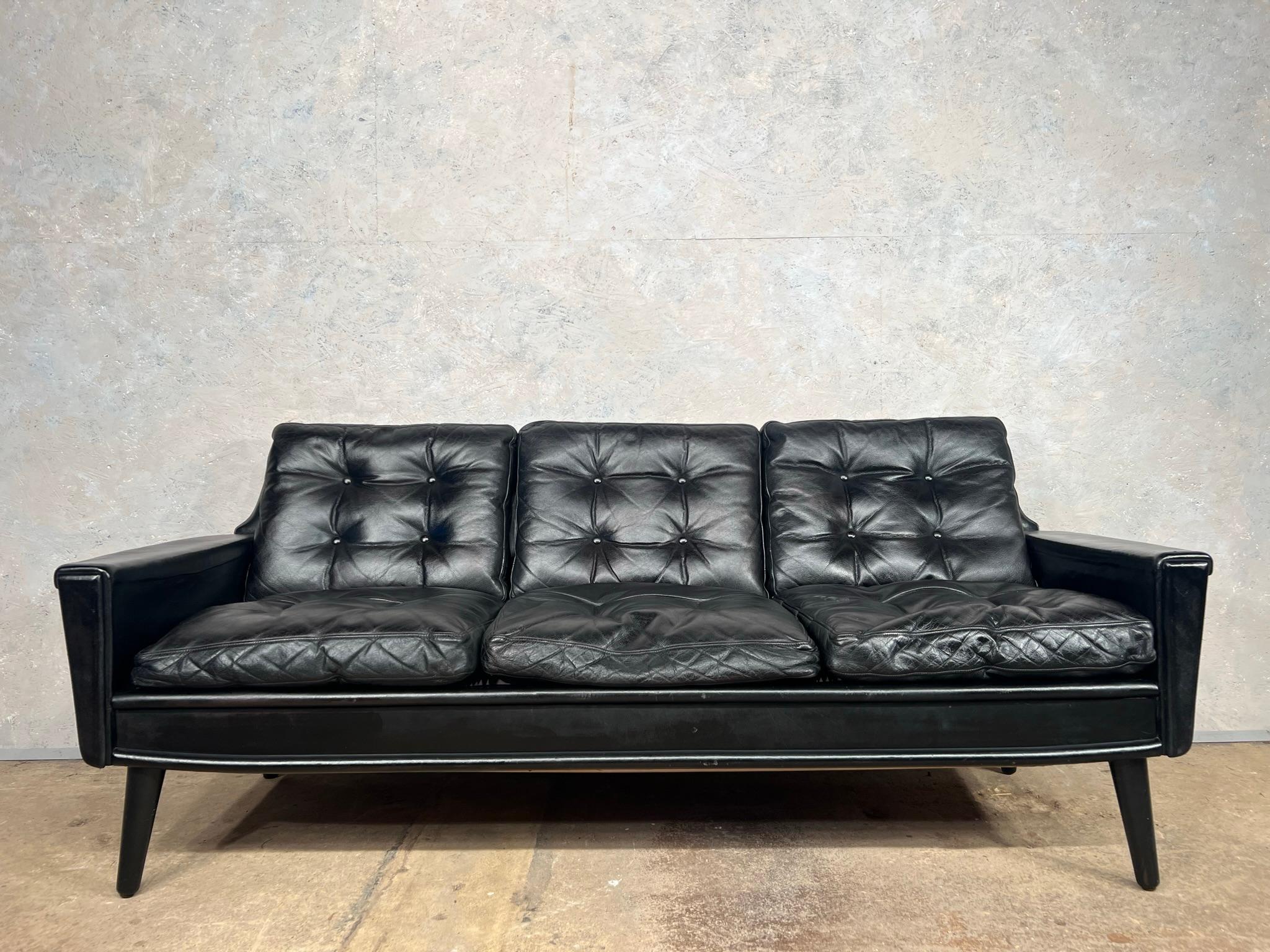 A Stylish Vintage Danish three seater black leather sofa. A great quality sofa, with a beautiful design, sits wonderfully on tapered legs.

Very comfortable to sit in, the cushions are filled with duck down, the sofa has a fantastic vintage look,