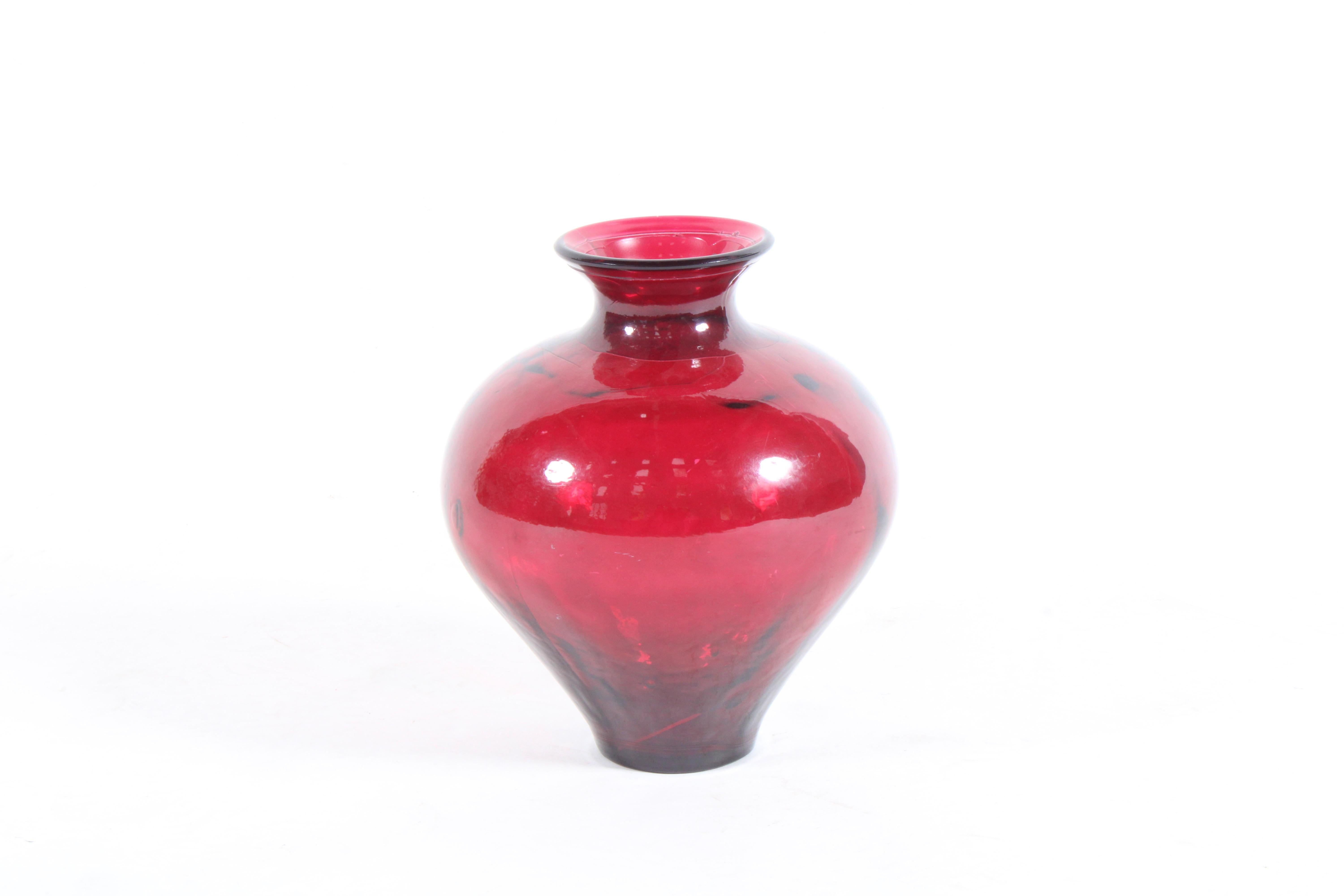 A beautifully proportioned and stylish vintage Ruby red glass vase. The perfect piece of home decor to style you table or sideboard with.