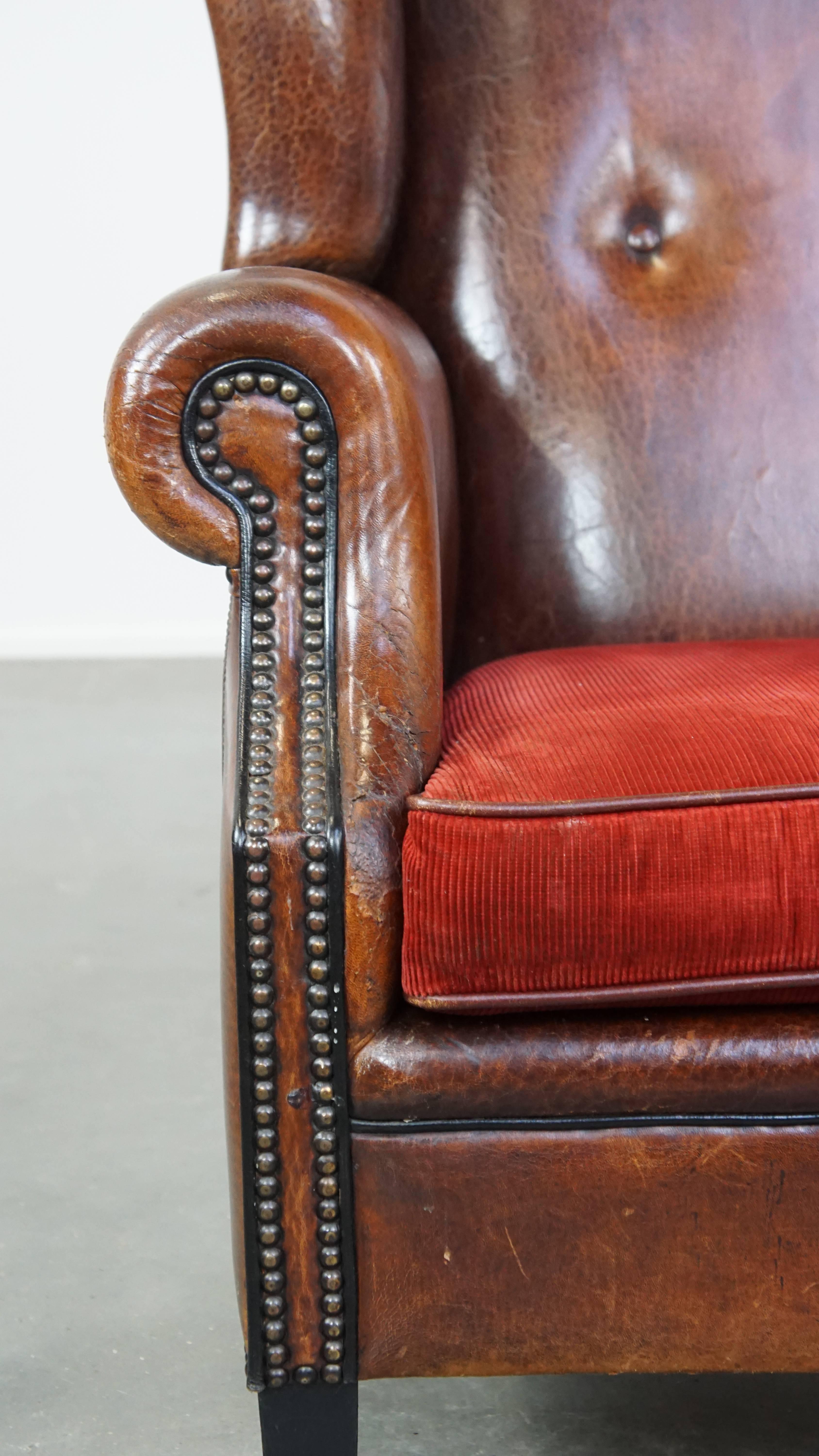 Stylish vintage, luxury sheepskin armchair with a red corduroy seat cushion For Sale 5