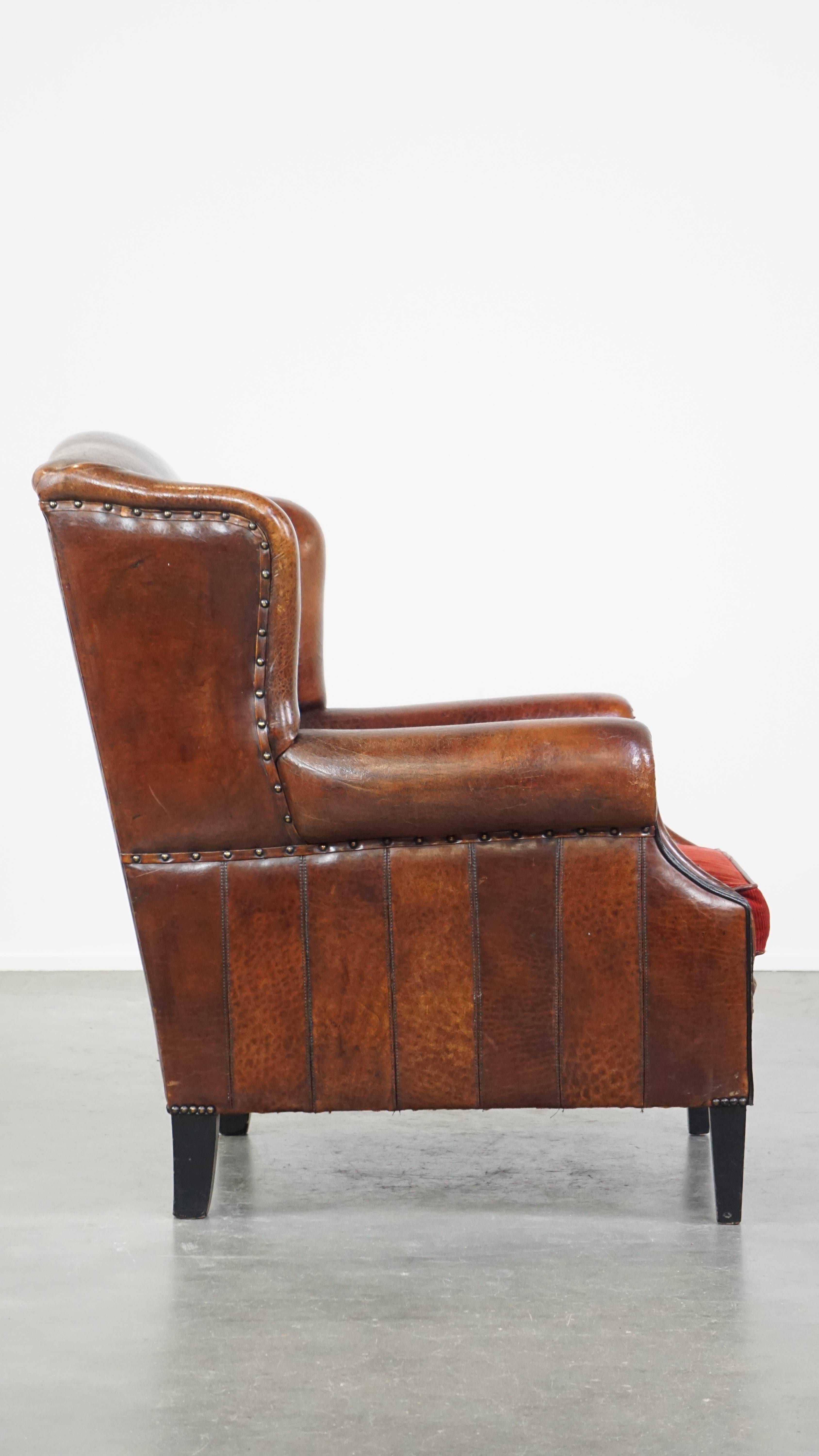 Hand-Crafted Stylish vintage, luxury sheepskin armchair with a red corduroy seat cushion For Sale
