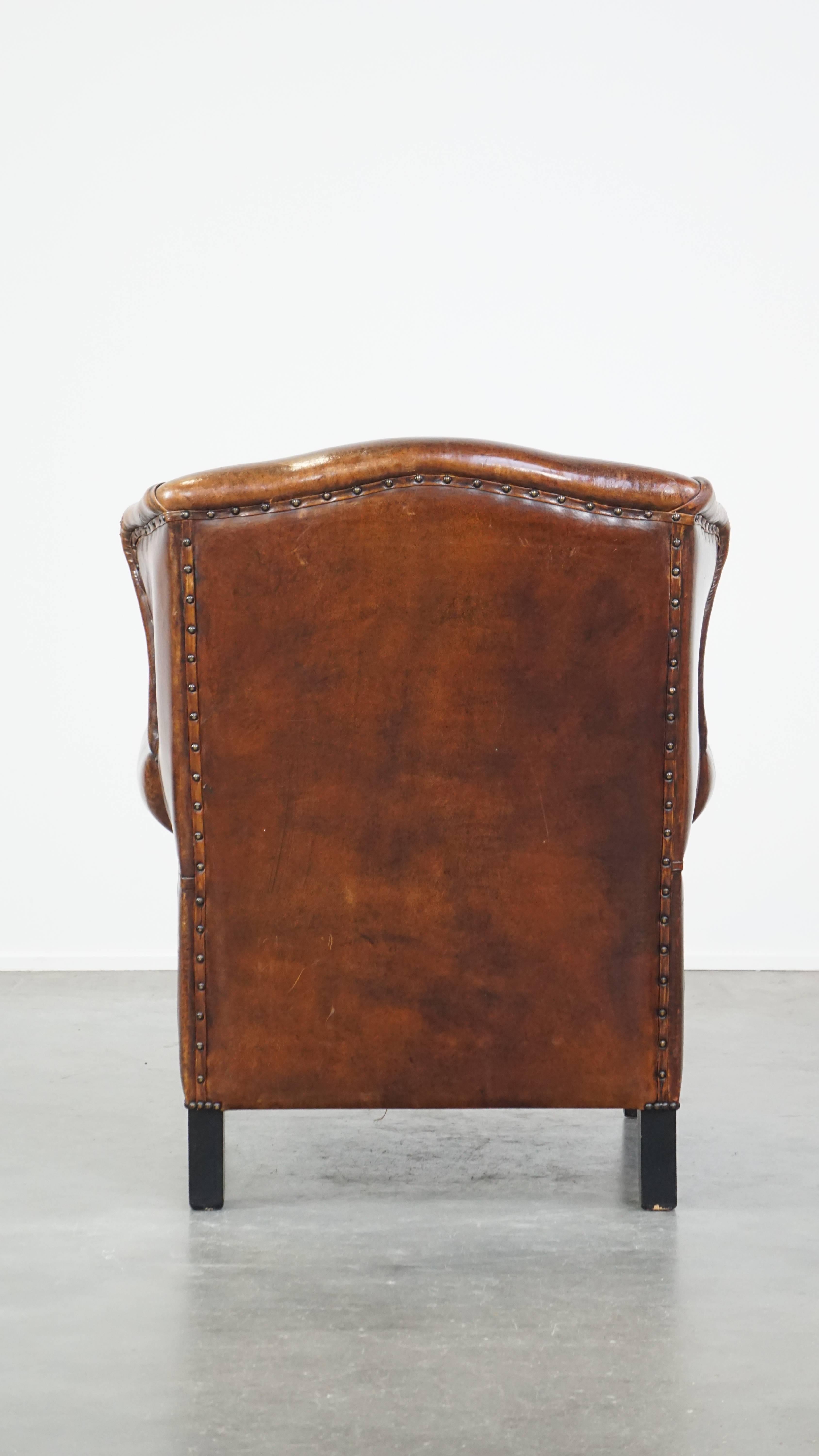 Stylish vintage, luxury sheepskin armchair with a red corduroy seat cushion In Good Condition For Sale In Harderwijk, NL