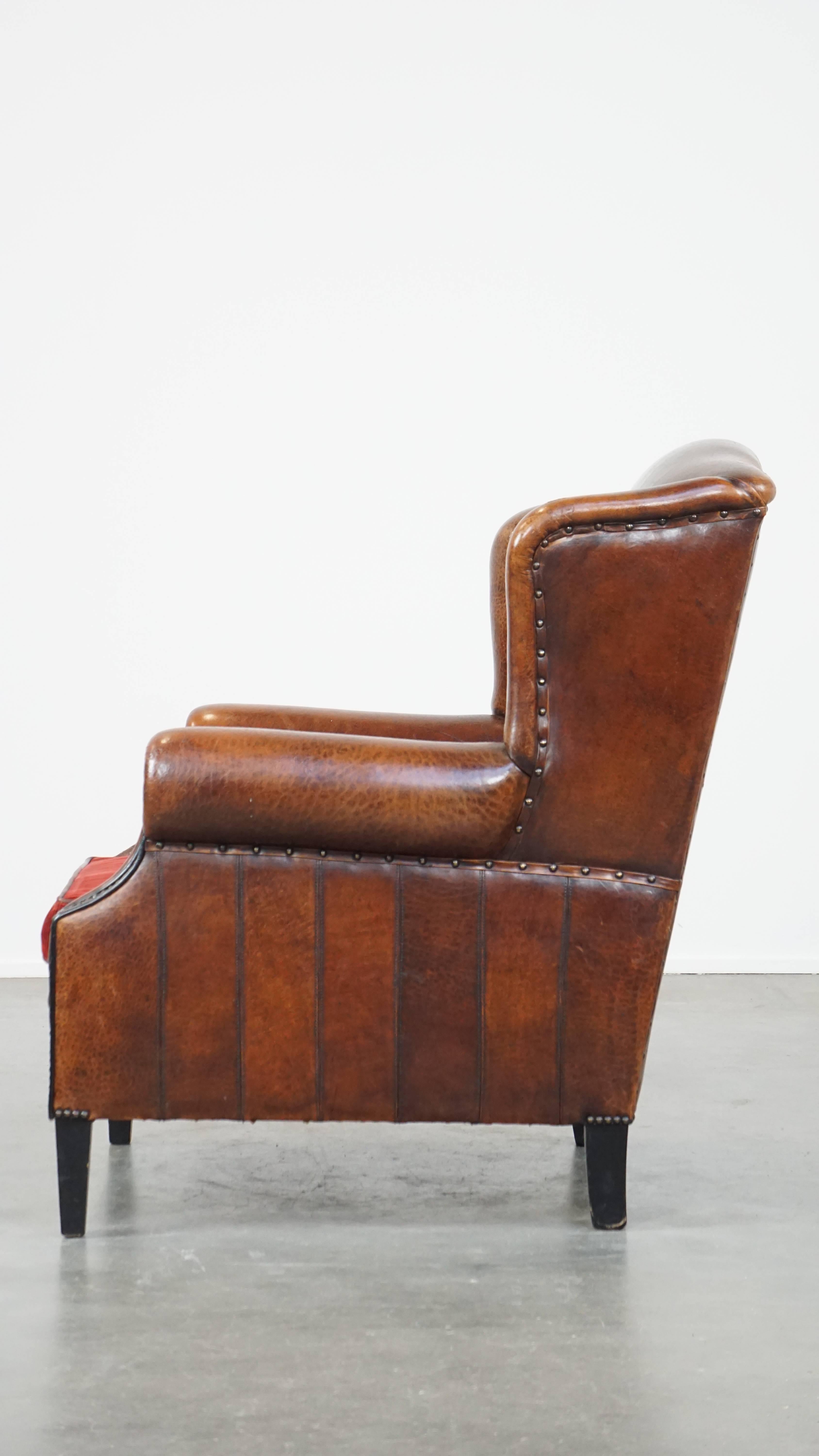 20th Century Stylish vintage, luxury sheepskin armchair with a red corduroy seat cushion For Sale