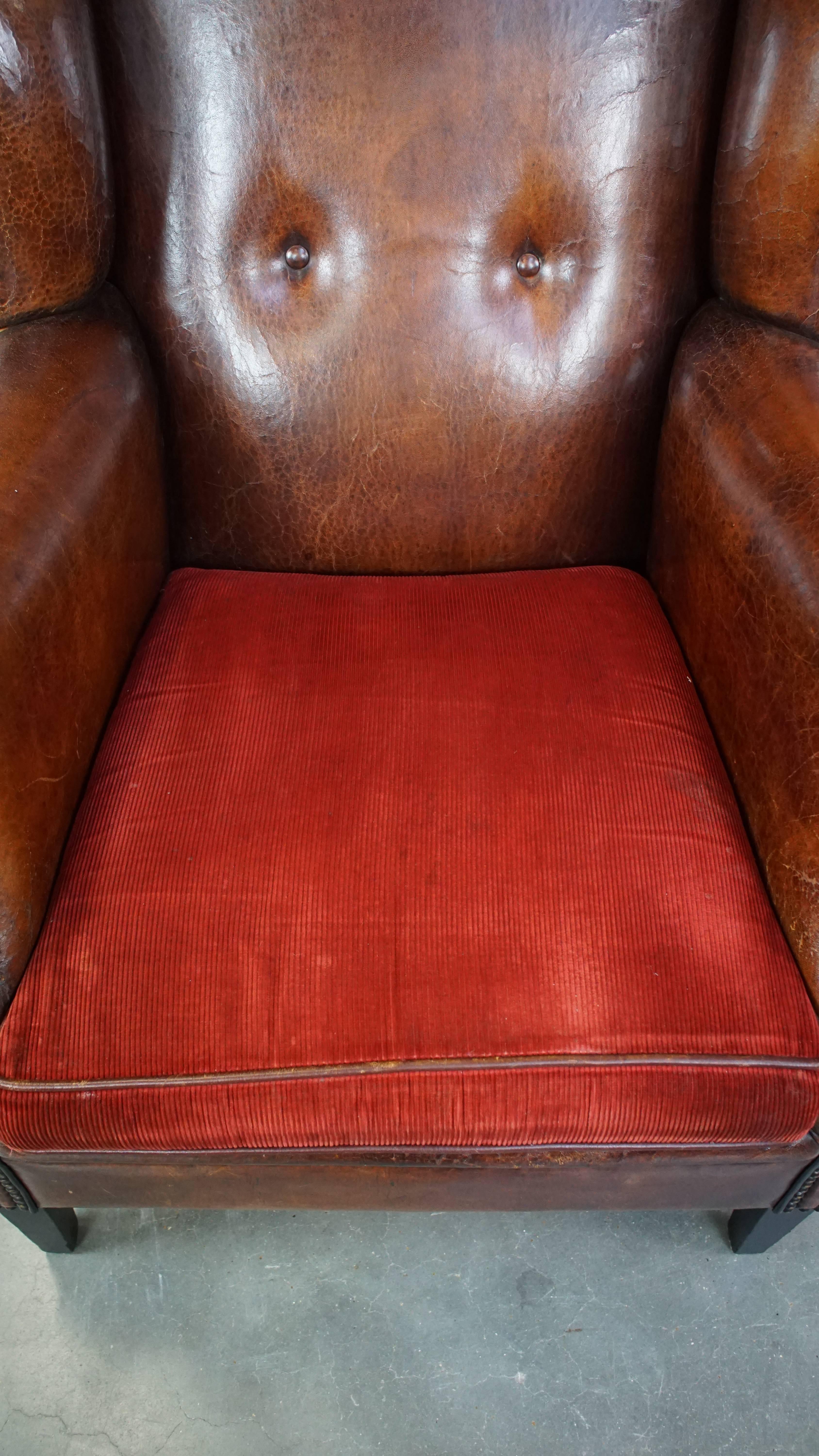 Sheepskin Stylish vintage, luxury sheepskin armchair with a red corduroy seat cushion For Sale