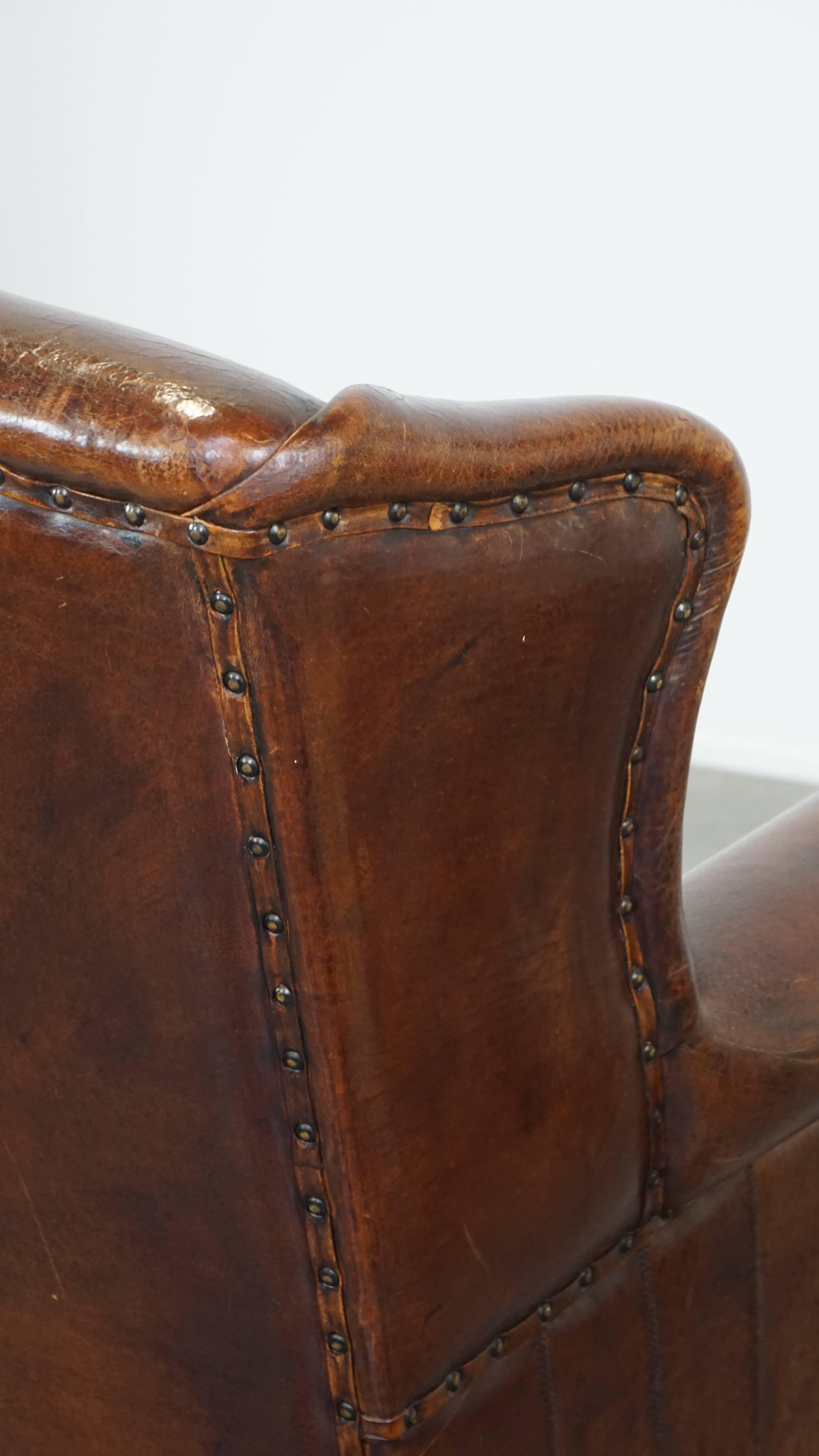 Stylish vintage, luxury sheepskin armchair with a red corduroy seat cushion For Sale 3