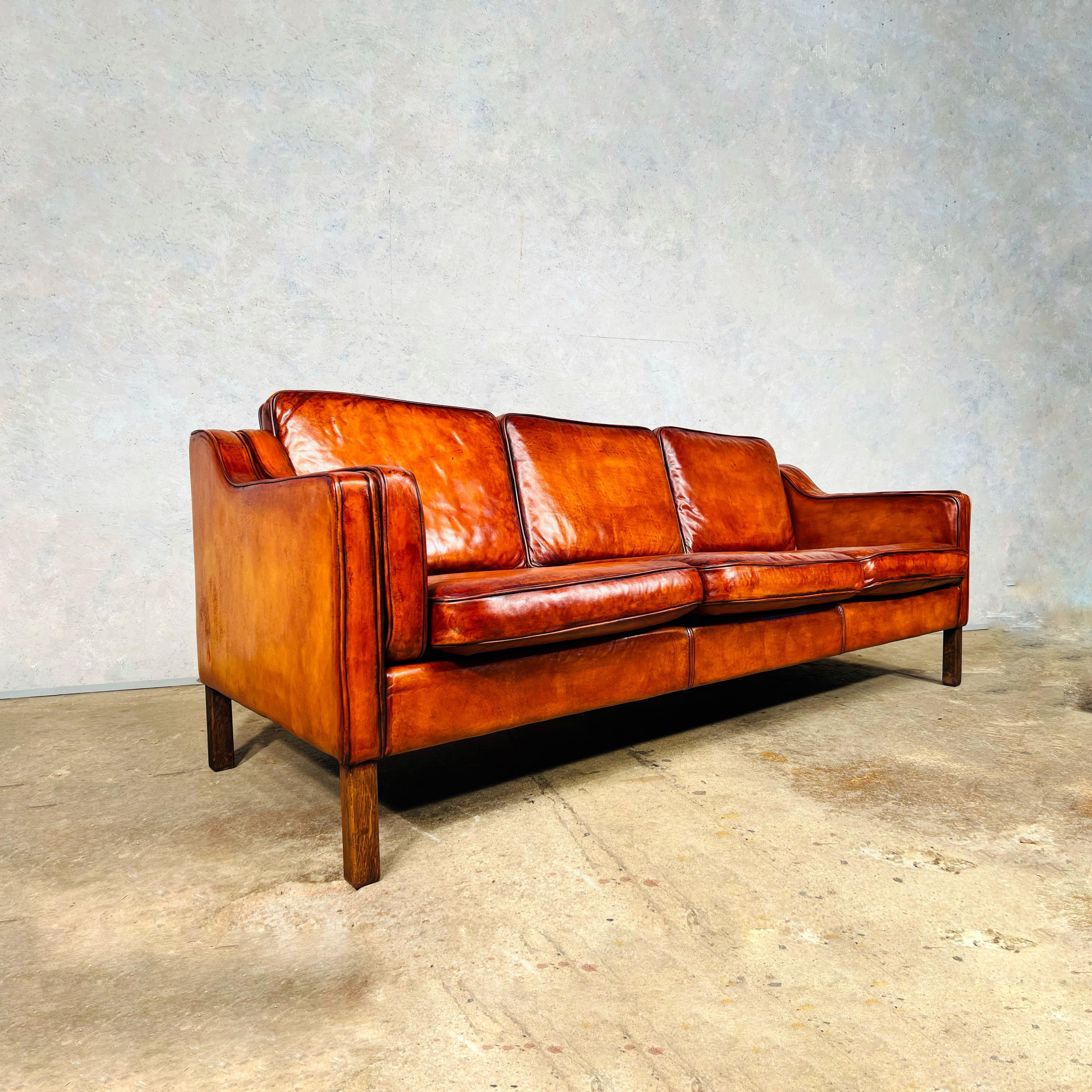 A very Stylish Vintage 1970 s sofa by Svend Skipper, great quality with thick pipping around the cushions. The Leather is a wonderful patinated cognac colour. Great design, sits beautifully, deep seated and very comfortable to sit in with feather