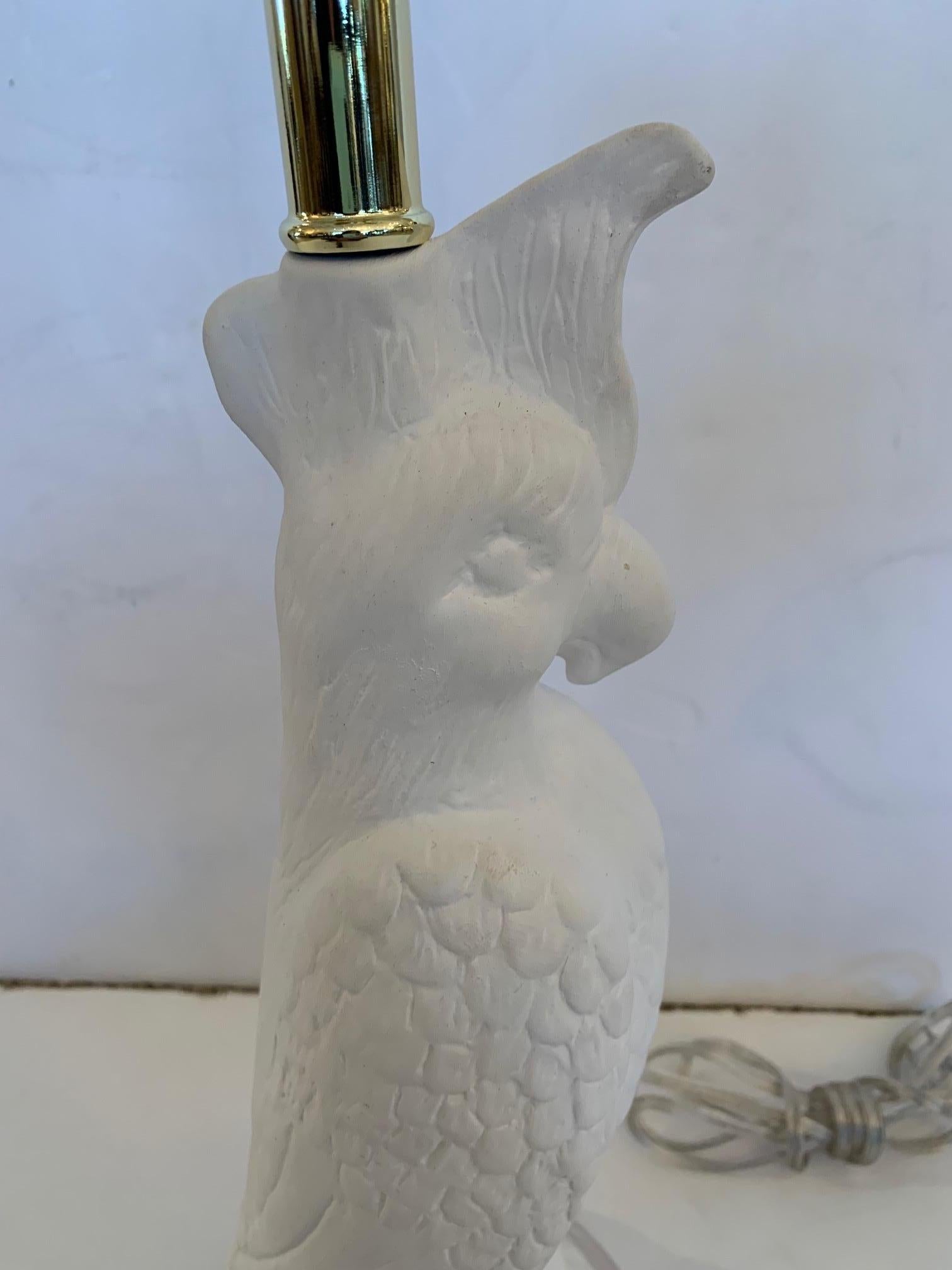 Stylish white ceramic parrot shaped table lamp having lucite base.