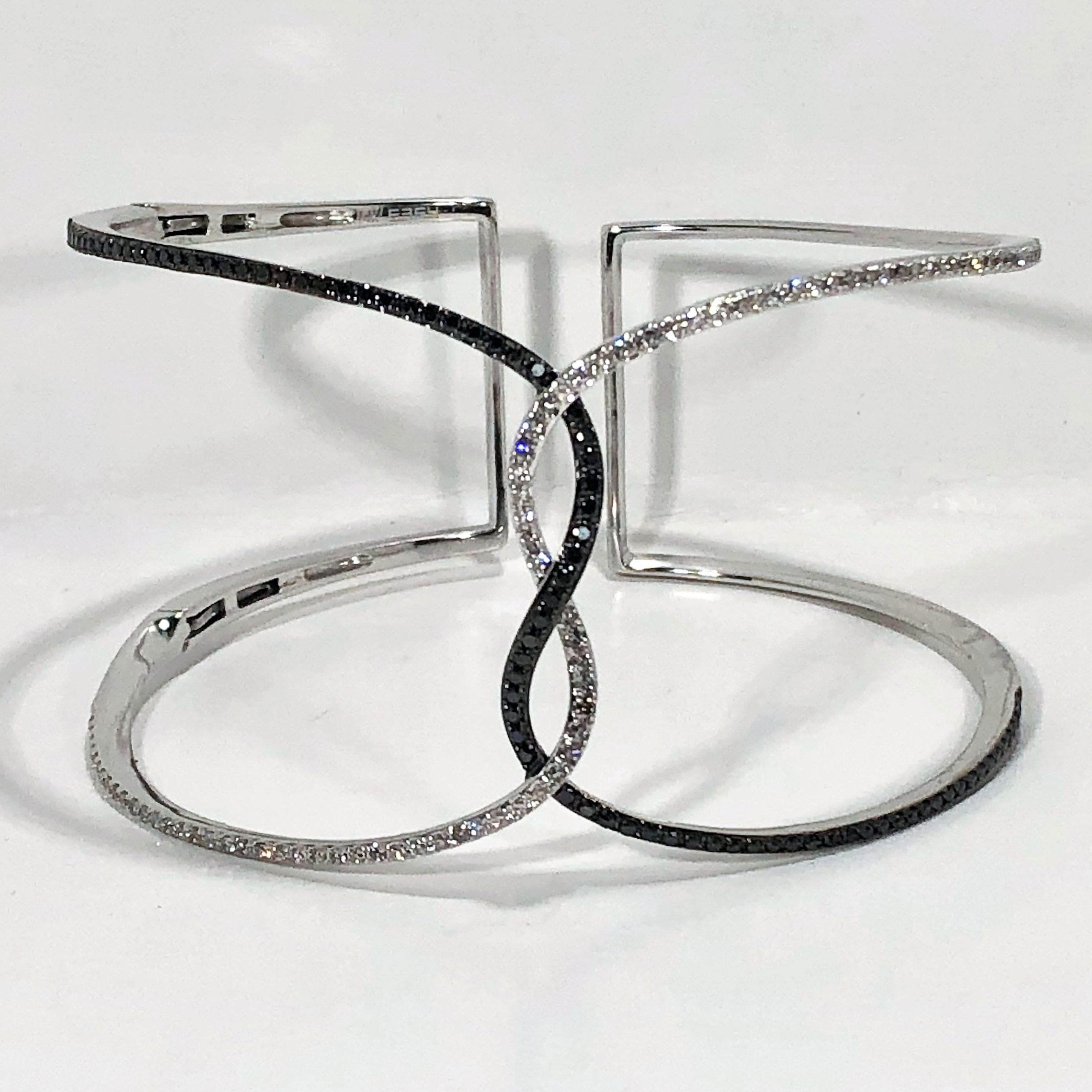 Stylish and lightweight, this easy to wear black and white diamond cuff by designer Effy is a great addition to your jewelry collection. Fashioned in 14k white gold and set with assorted black and white diamonds on the front side weighing an