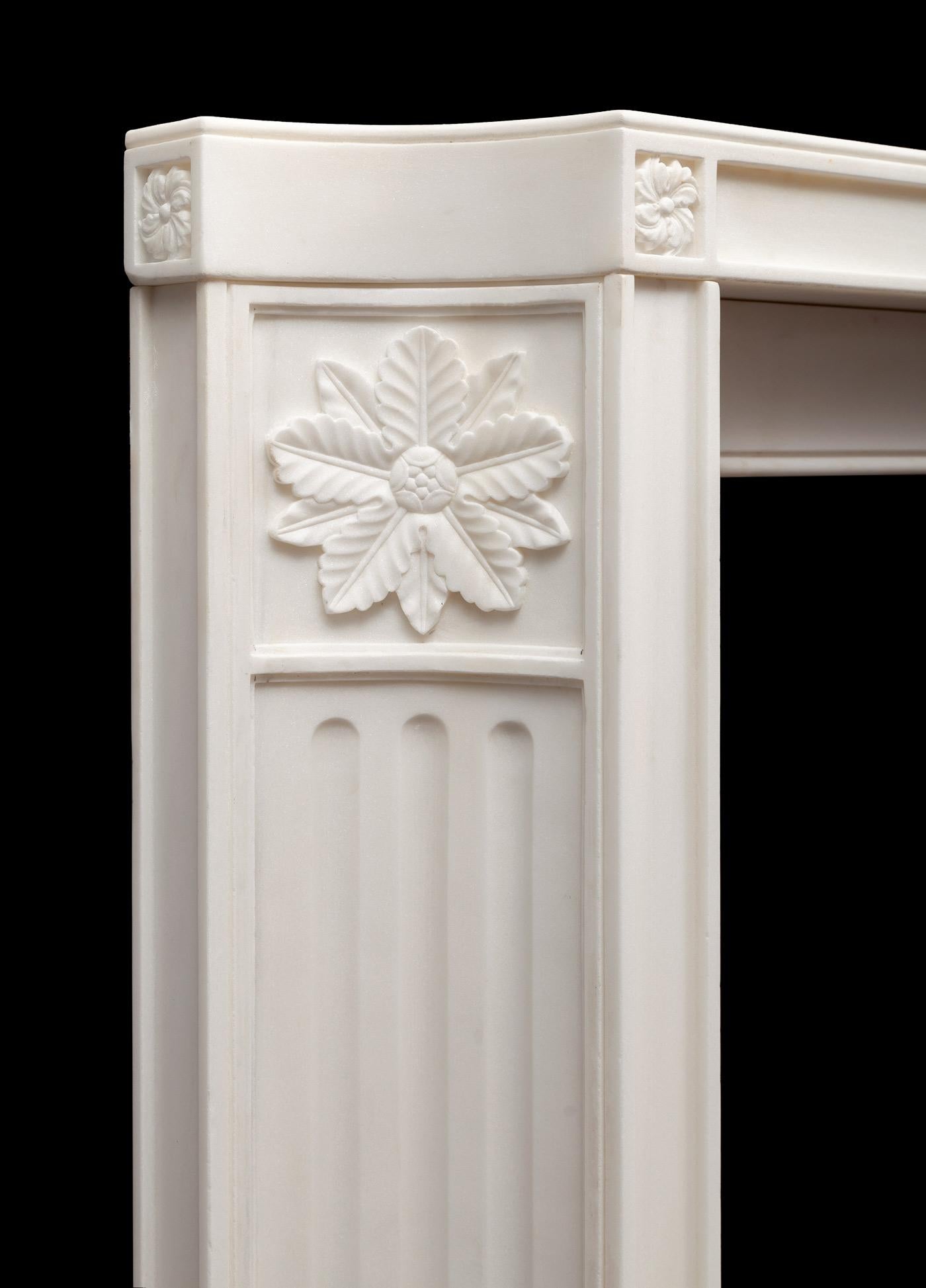 A very stylish hand carved white marble fireplace, worked from solid blocks of marble and presented with a matte finish. Inspired by the pared back classical revival taste of the early 20th century.
Equally at home in a period or contemporary
