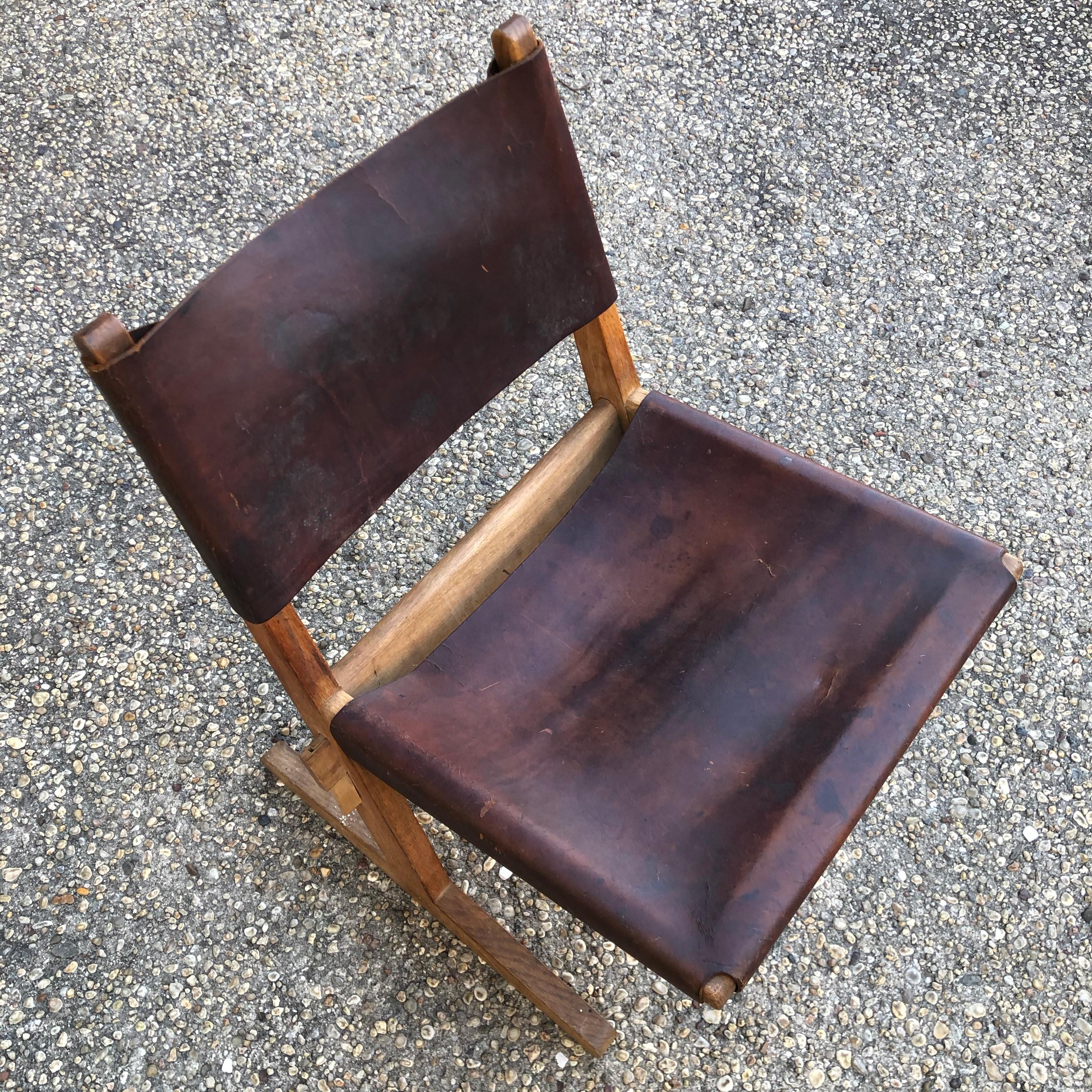 Modern wood framed chair with saddle leather seat and back..... a great accent chair.