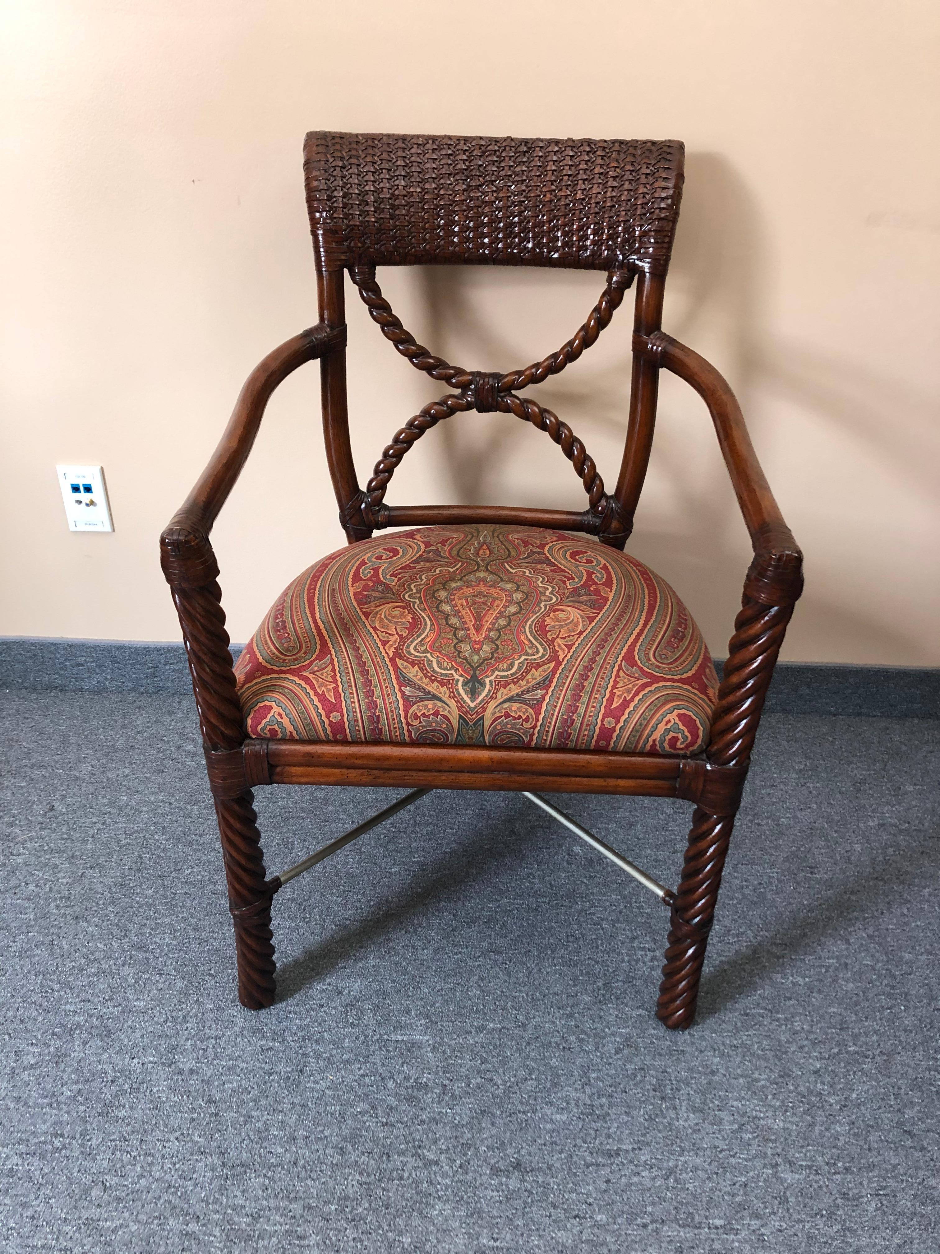Handsome wood and rattan armchair having twisty carved wood legs and back and wrapped rattan accents. Seat is upholstered in a traditional paisley print. Metal stretchers with rattan wrapped center. Makes a perfect desk chair.
By Lecor Furniture