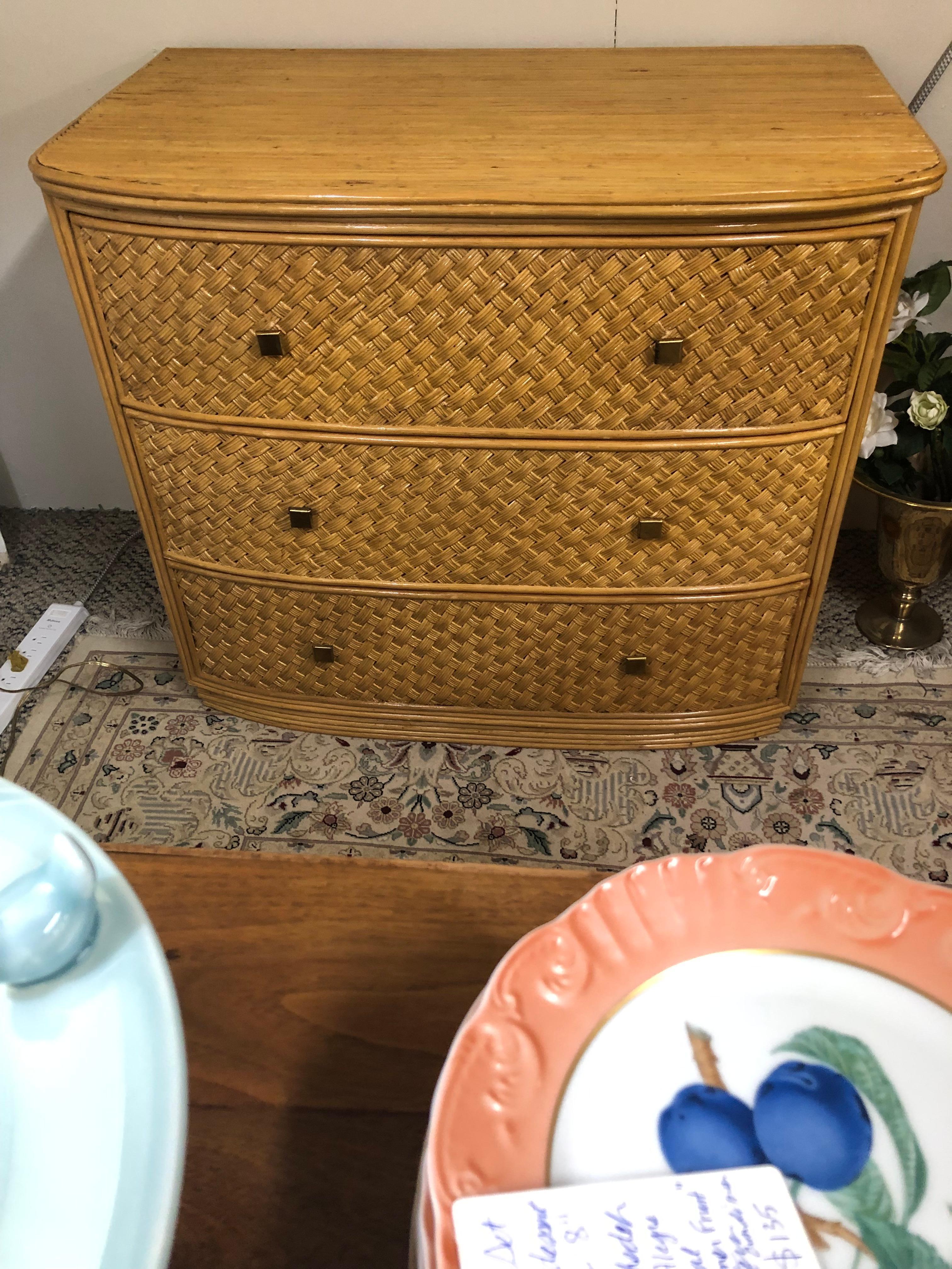 Stylish medium sized vintage chest of drawers made of bamboo and lacquered woven rattan having 3 drawers.  Exterior drawer height: 8 1/4