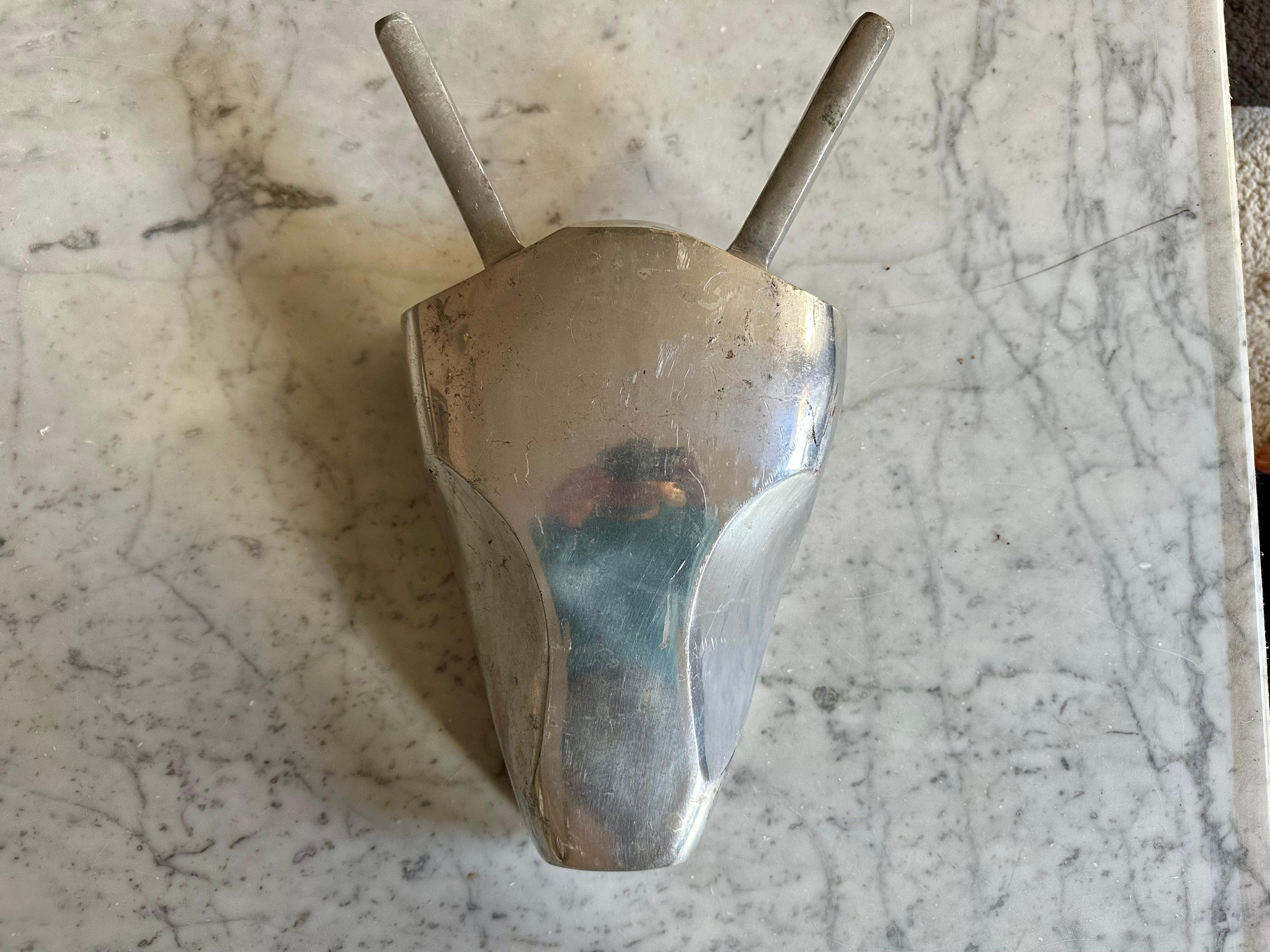 This striking and highly decorative stylized aluminum bull head dates back to the mid-20th century and was originally used as a shop sign for an Italian butcher’s business. The design, characterized by its clean, minimalist lines, conveys a timeless