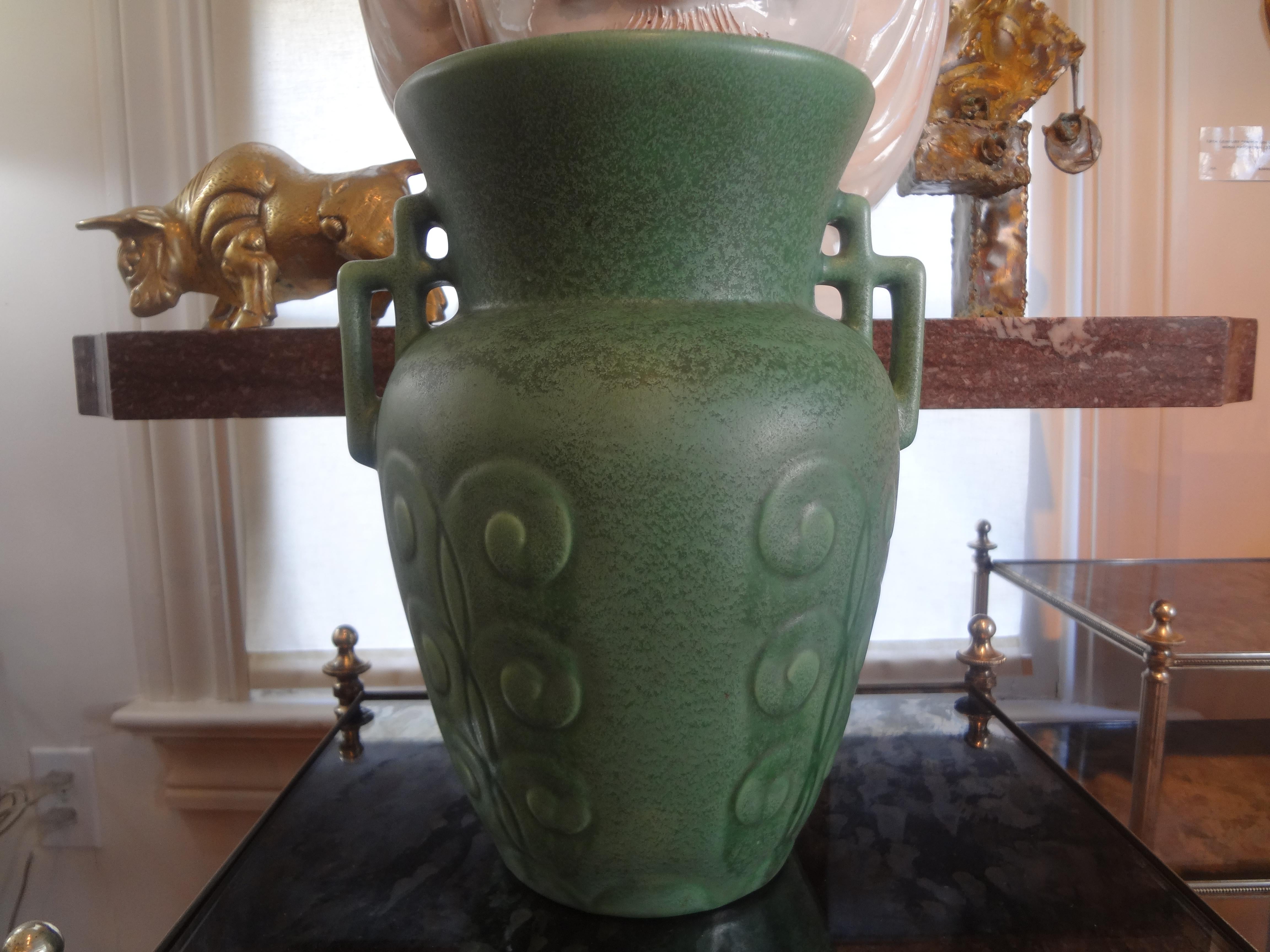 Beautiful stylized Art Deco glazed pottery vase or urn in a gorgeous shade of celadon green. This great vase has interesting geometric handles and a wonderful mottled glaze and dates to the 1930s. This is such a stunning form that you that you can