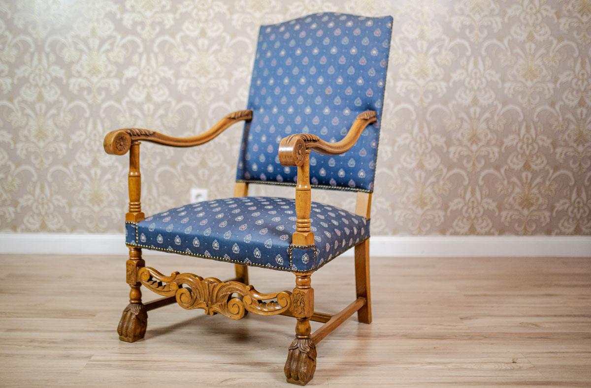 We present you a grand, carved walnut armchair with an upholstered seat and a backrest.
The front legs are connected with a decorative openwork stretcher, and finished with feet in the shape of bird talons.
This piece of furniture is from the