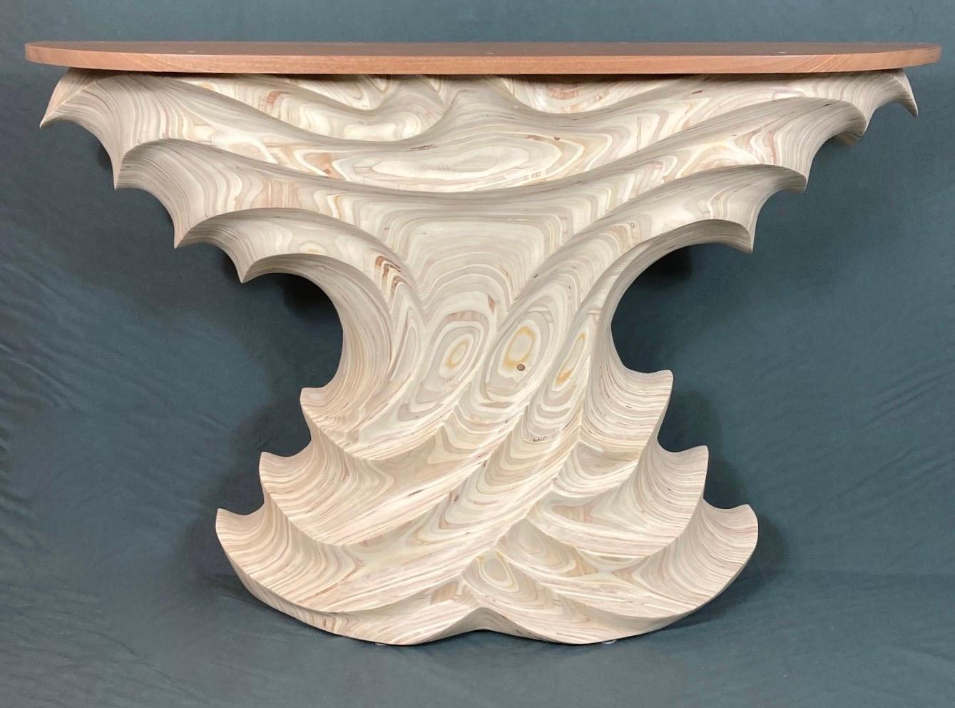 Rich natural tones and freeform sculptural form set this Sapele wood top console table apart from all others. It is a unique Organic Modern stylized table. Created by stacking multiple layers of Birch Plywood and then carved to expose the different