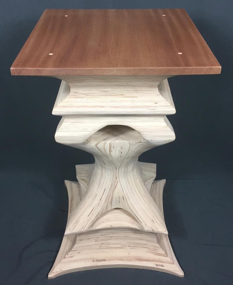 Rich natural tones and freeform sculptural form set this Sapele wood top side table apart from all others. It is a unique Organic Modern stylized table. Created by stacking multiple layers of Birch Plywood and then carved to expose the different