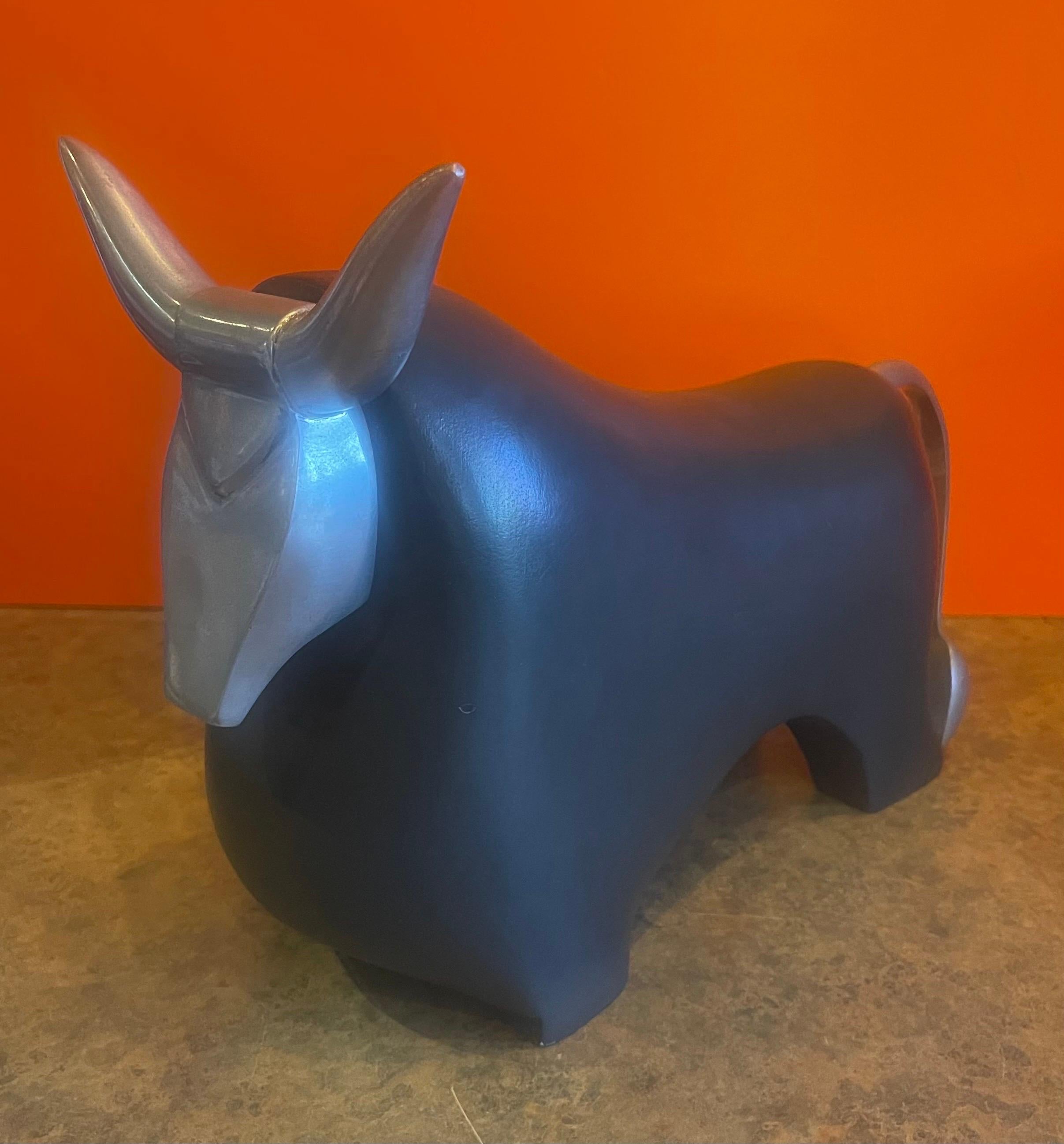A very cool stylized ceramic and aluminum charging bull sculpture, circa 1990s. The piece is in very good vintage condition with no visible chips or cracks and measures 4.5