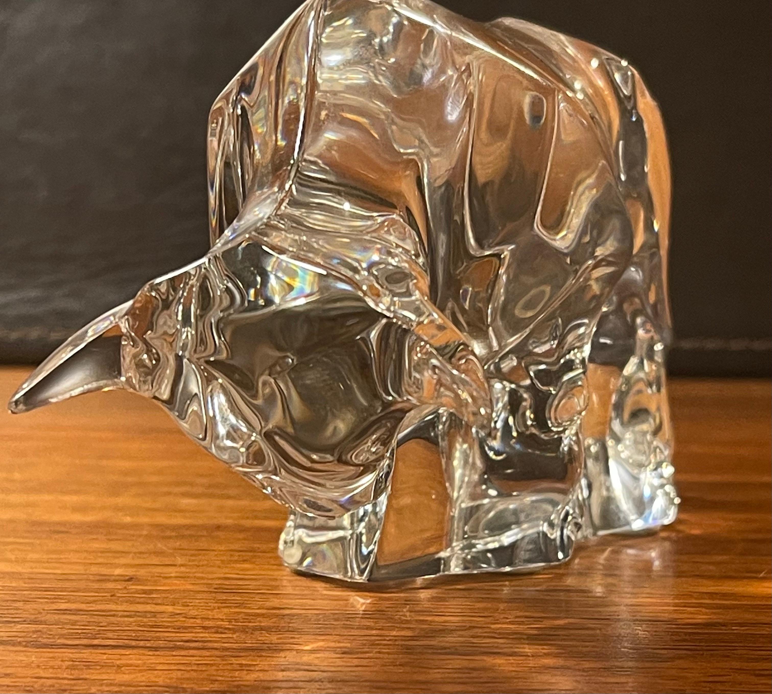 Gorgeous stylized crystal charging bull sculpture by Baccarat, circa 1990s. The piece is in excellent condition with no visible imperfections and has great clarity. Signed on the lower right, the piece measures 6.5