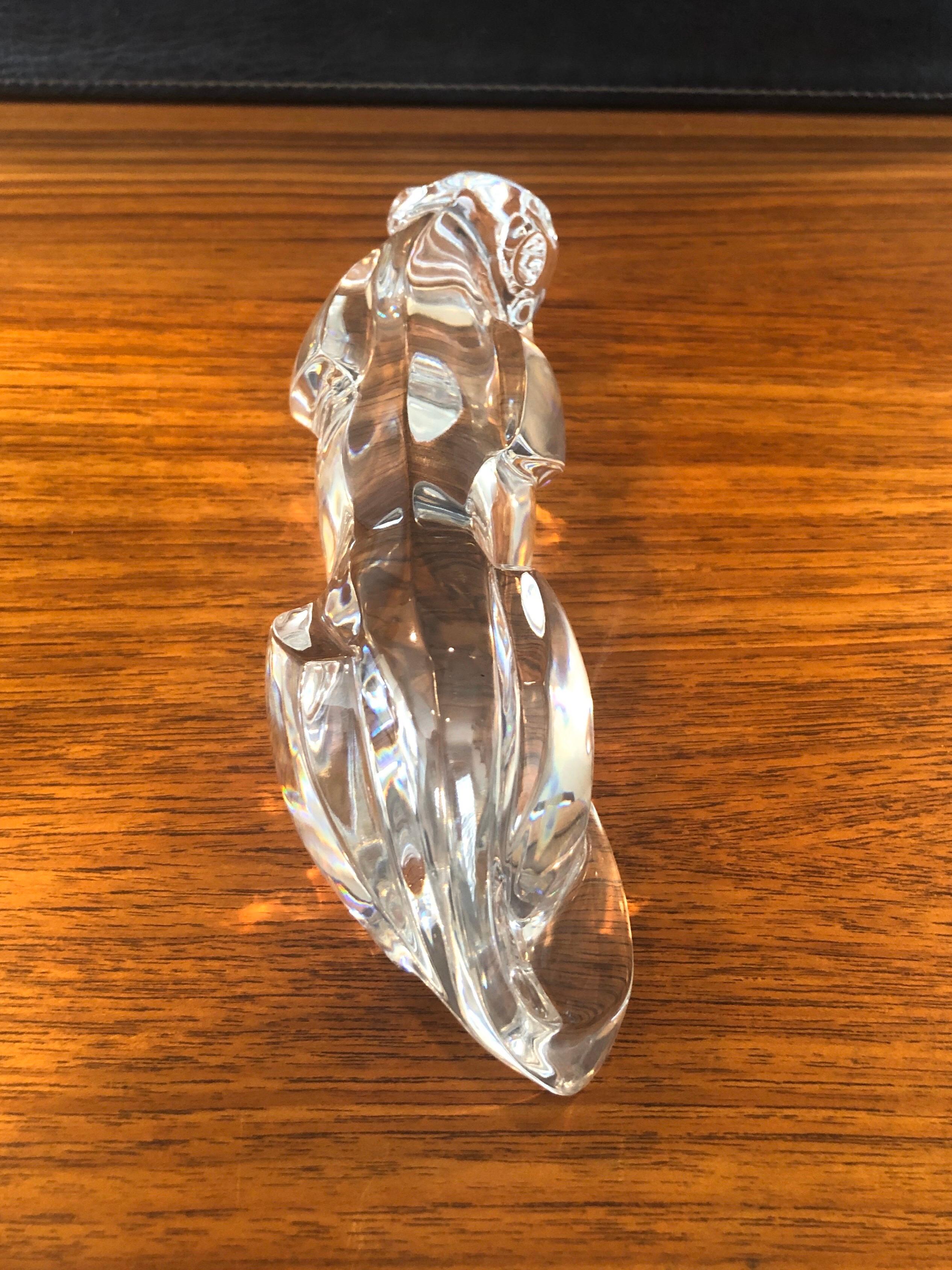 Gorgeous stylized crystal panther / jaguar sculpture by Baccarat, circa 1990s. The piece is in excellent condition with no visible imperfections and has great clarity. Signed on the lower right, the piece measures 10.25