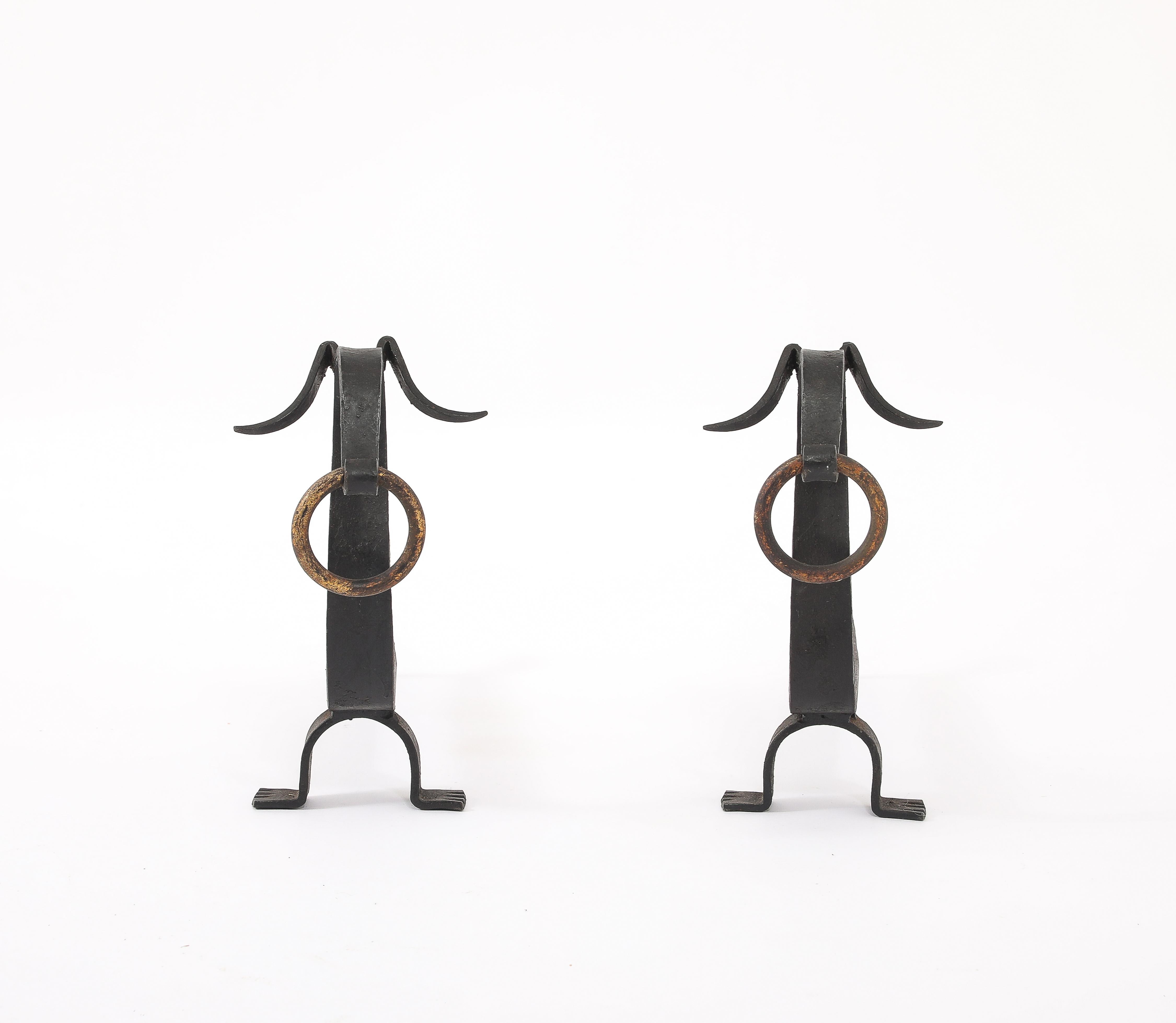 Elegant stylized andirons in wrought iron and brass.