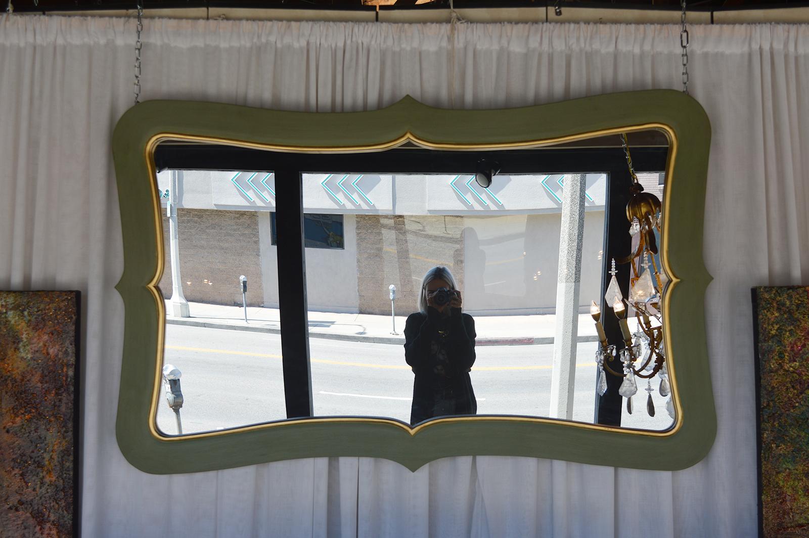 Mirror with painted green and gold frame.