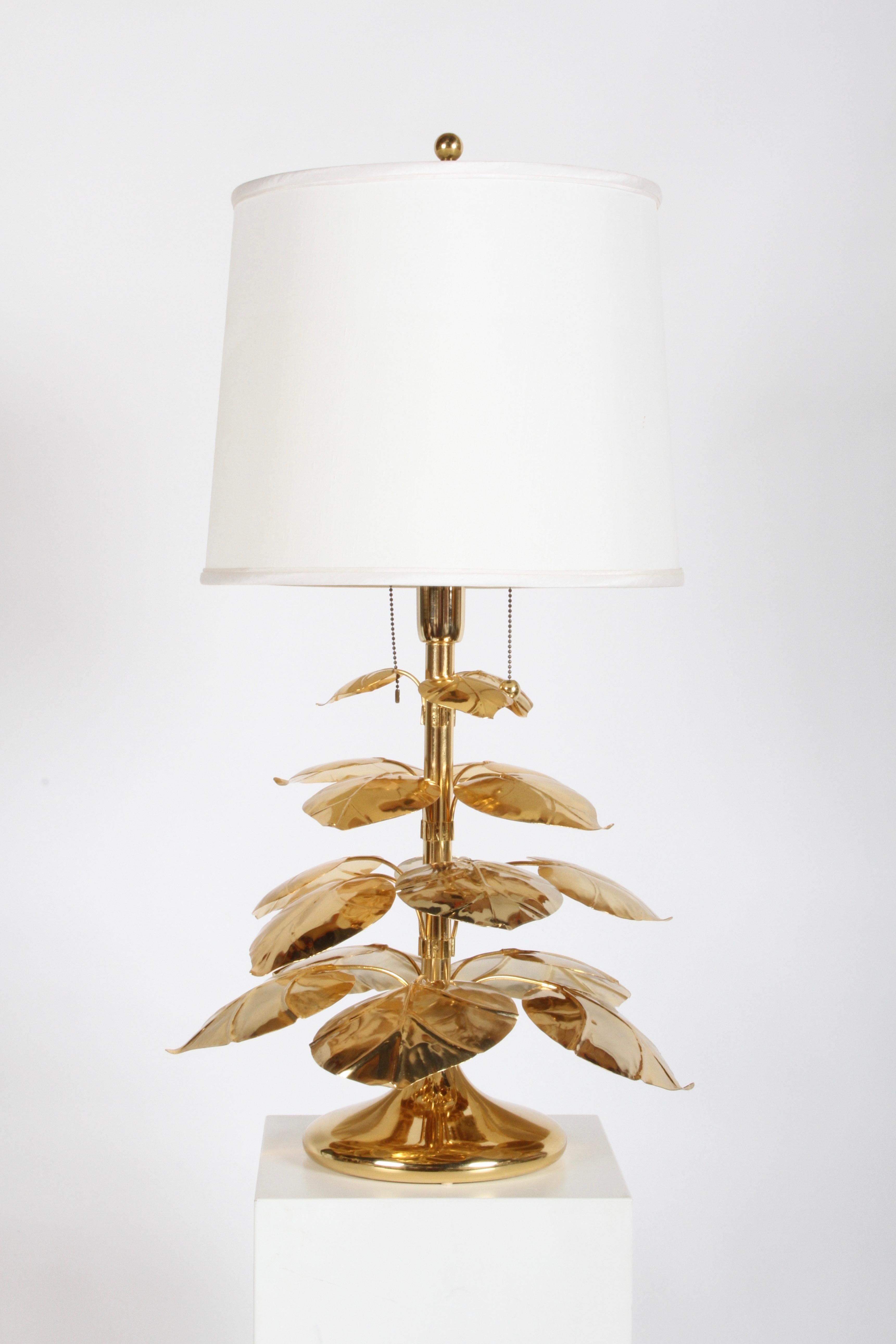 Unique stylized Hollywood Regency Italian 24-karat gold-plated table lamp with tiered Rhubard leaves on tulip form base. Various sized leaves, top tier leaves measure 3.25