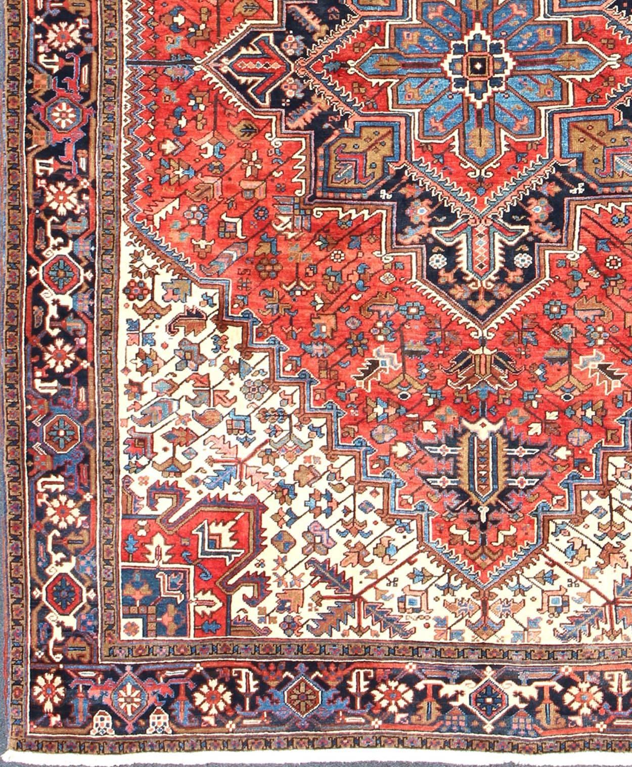 Stylized Semi Antique Persian Heriz rug with center Medallion Design in Rust Red and Blue, rug dsp-rmk9719, country of origin / type: Iran / Heriz, circa 1950

This beautiful semi antique Persian Heriz carpet from the mid-20th century (circa 1950)