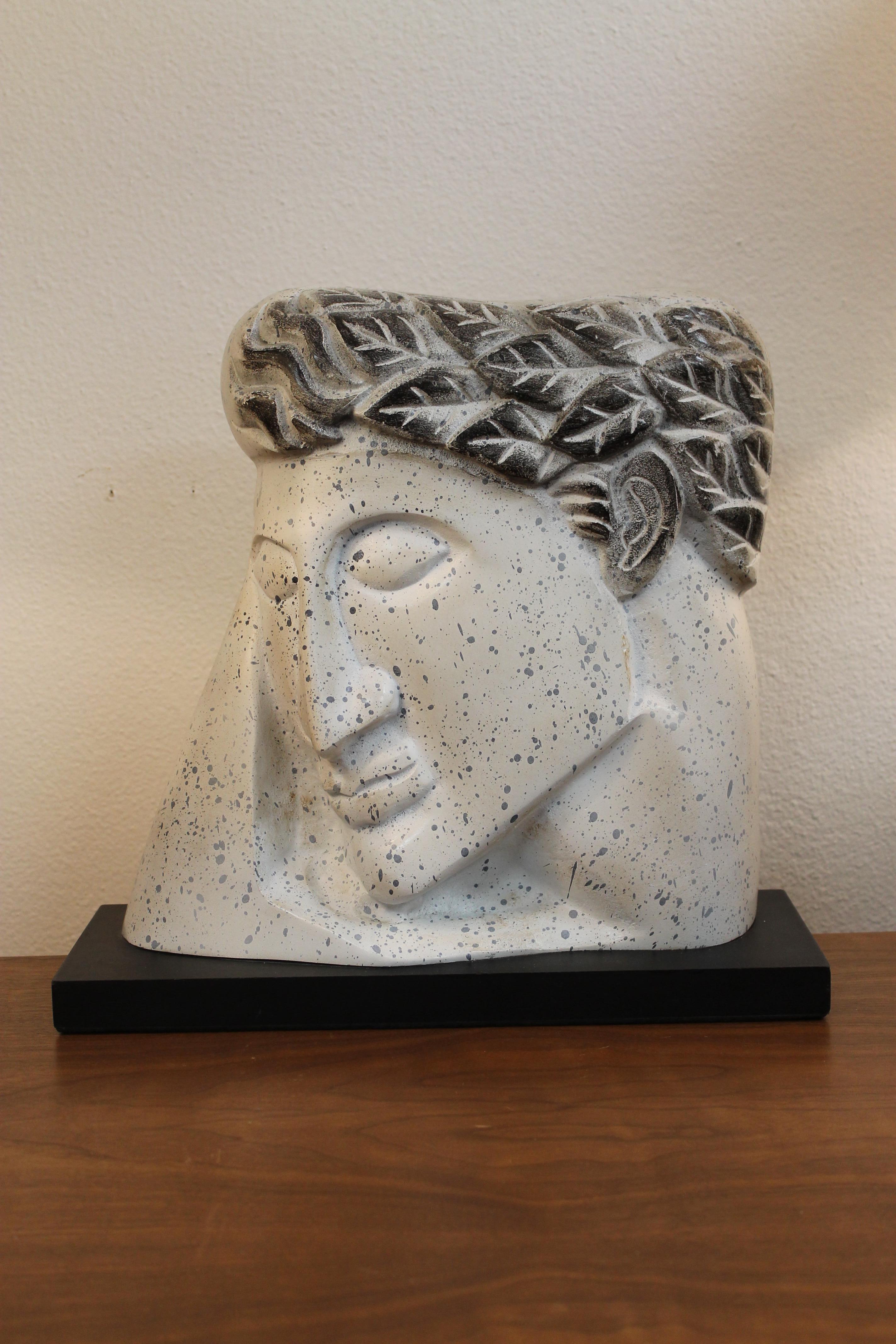 Stylized plaster head on wood stand. Piece isn't signed. Ceramic portion is 13