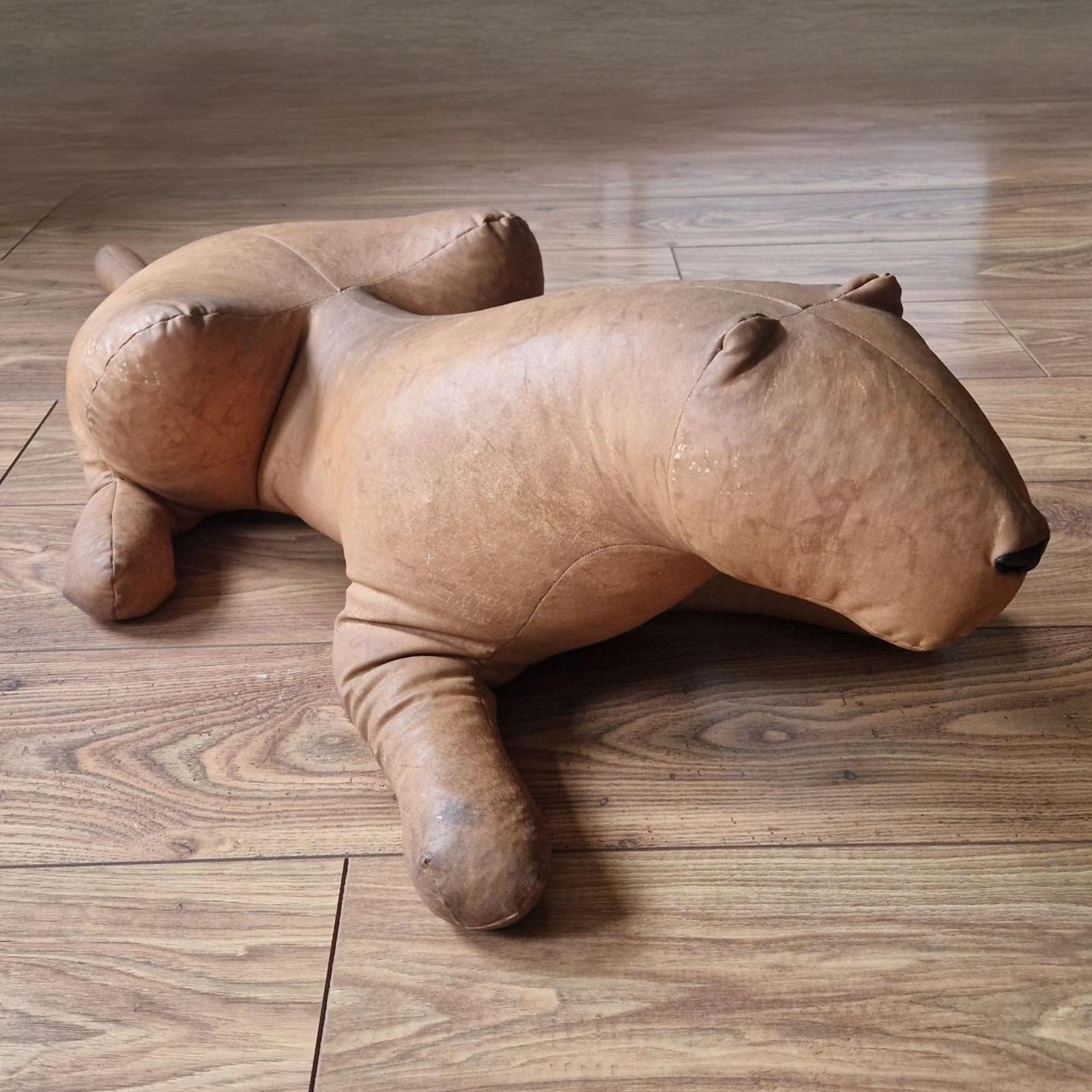 Stylized art deco style stuffed jaguar. Made from a sort of waxed nylon fabric and filled with polystyrene. 
Marked with the makers mark underneath. 
It has no tears or holes. Underneath there are darker scuffs of it sitting on a floor. The fabric